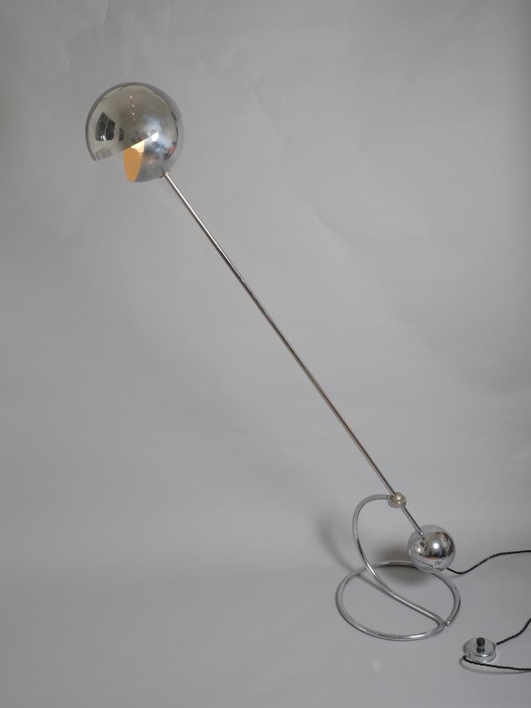 A chrome counterbalance floor lamp designed by Paolo Tilche c1970. 

With an adjustable spherical shade to control light. and a heavy, spherical base that acts as a counterweight.

Light can be positioned from 45 to 180 degrees.

Re wired. Will