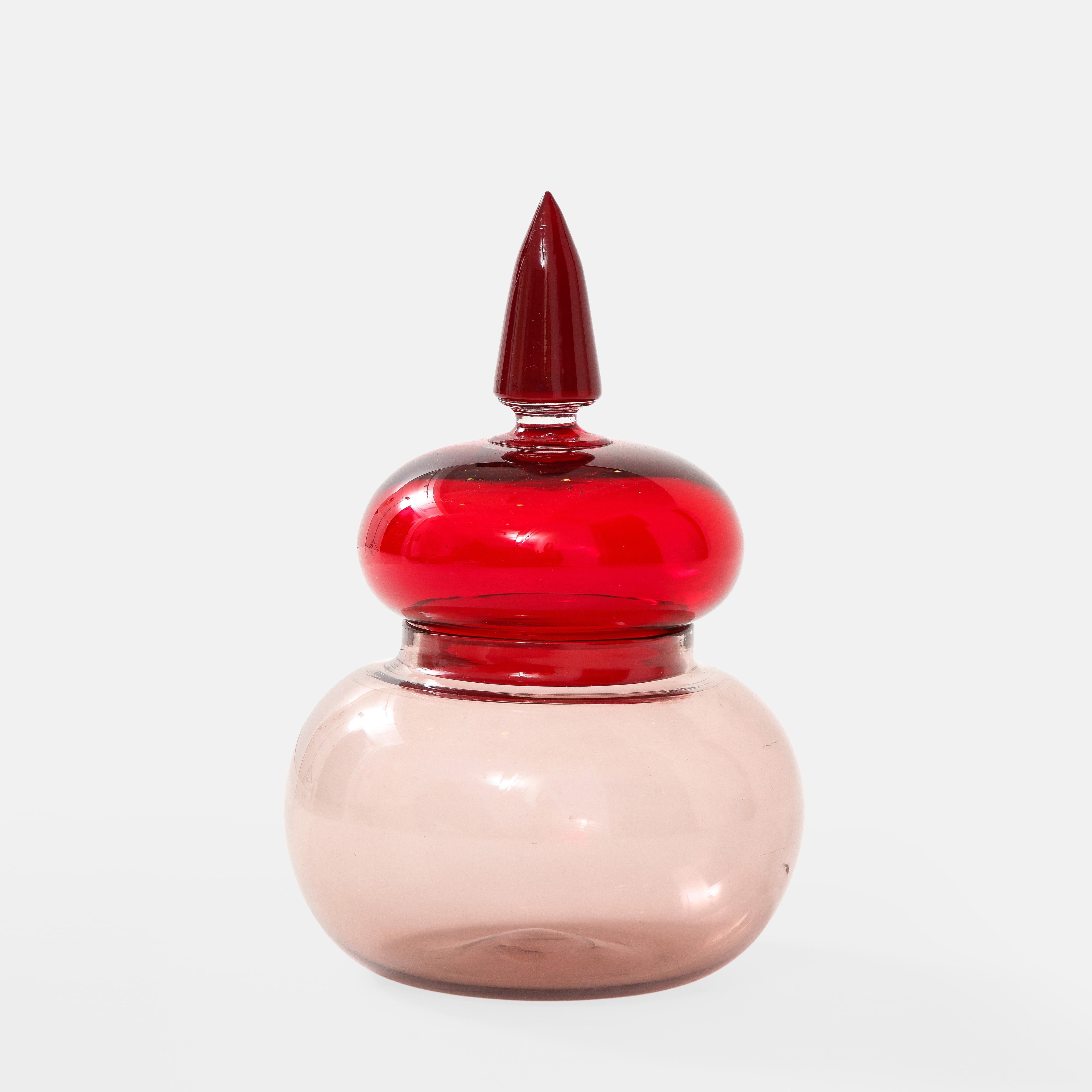 Paolo Venini for Venini rare apothecary jar or vessel in red and mauve blown glass.  This classic and elegant vessel comes from a series designed by Paolo Venini in 1959 inspired by apothecary jars from the 19th century.  
Three-line acid stamp to