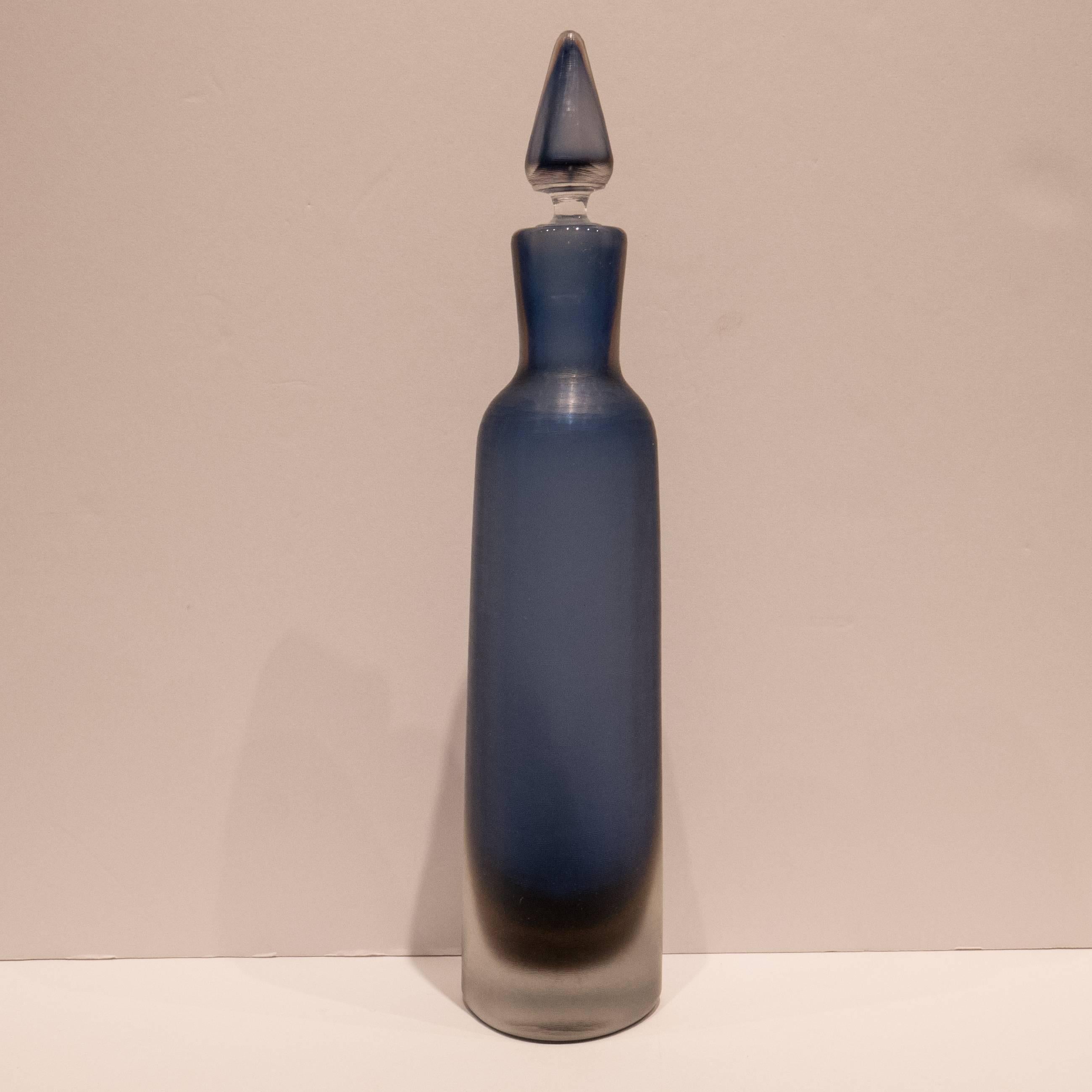 Triangular-shaped Sommerso glass decanter/bottle and stopper with inciso technique surface; blue and purple color in clear matrix. A 1956 Paolo Venini design, and a late 1950s Venini production with the three-line acid signature