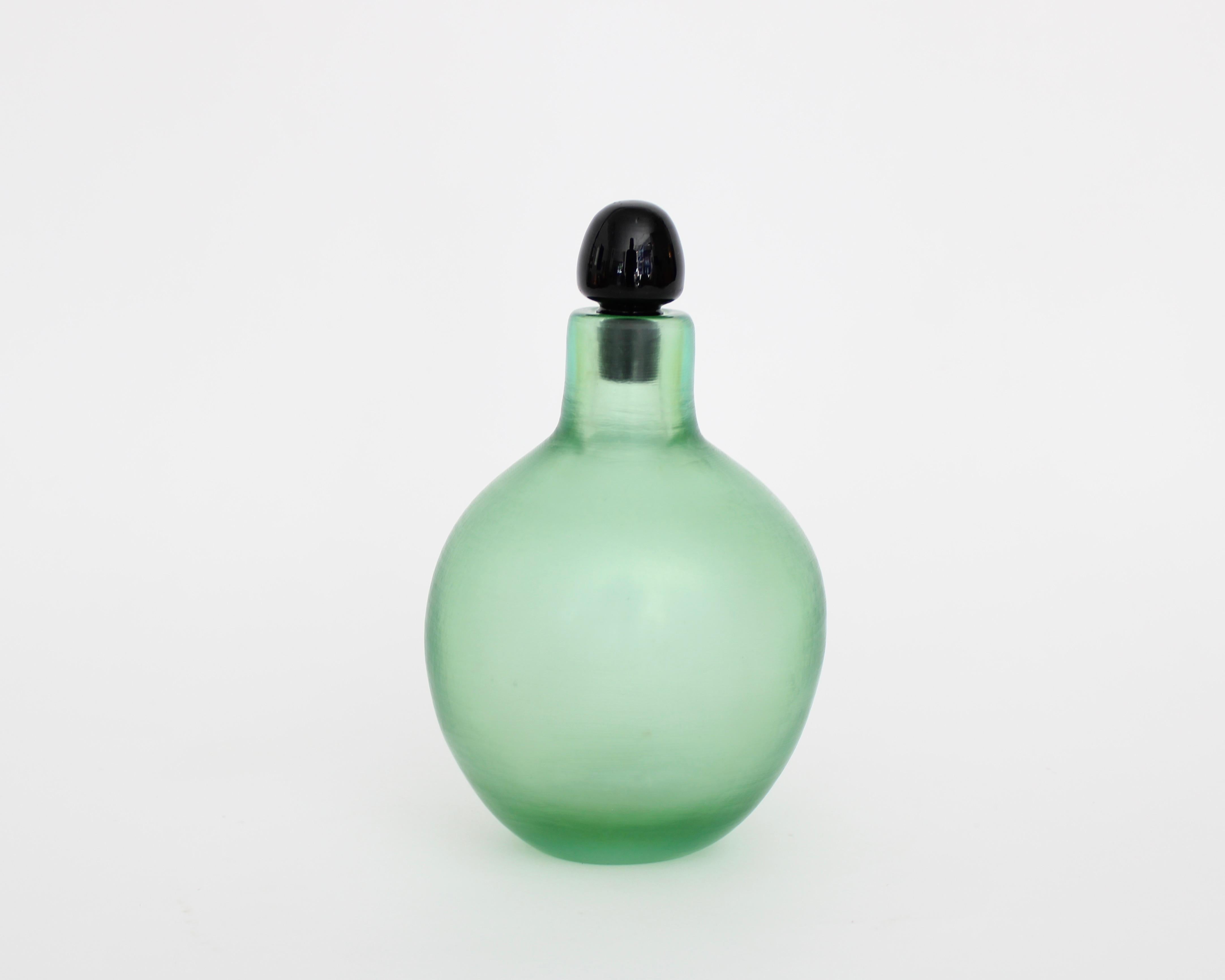 Paolo Venini (1895-1959) for Venini Inciso bottle, Murano, Italy, circa 1950
Green wheel-carved glass and original black stopper
Three-line acid stamp 'Venini Murano Italia'
Measures: 4.5