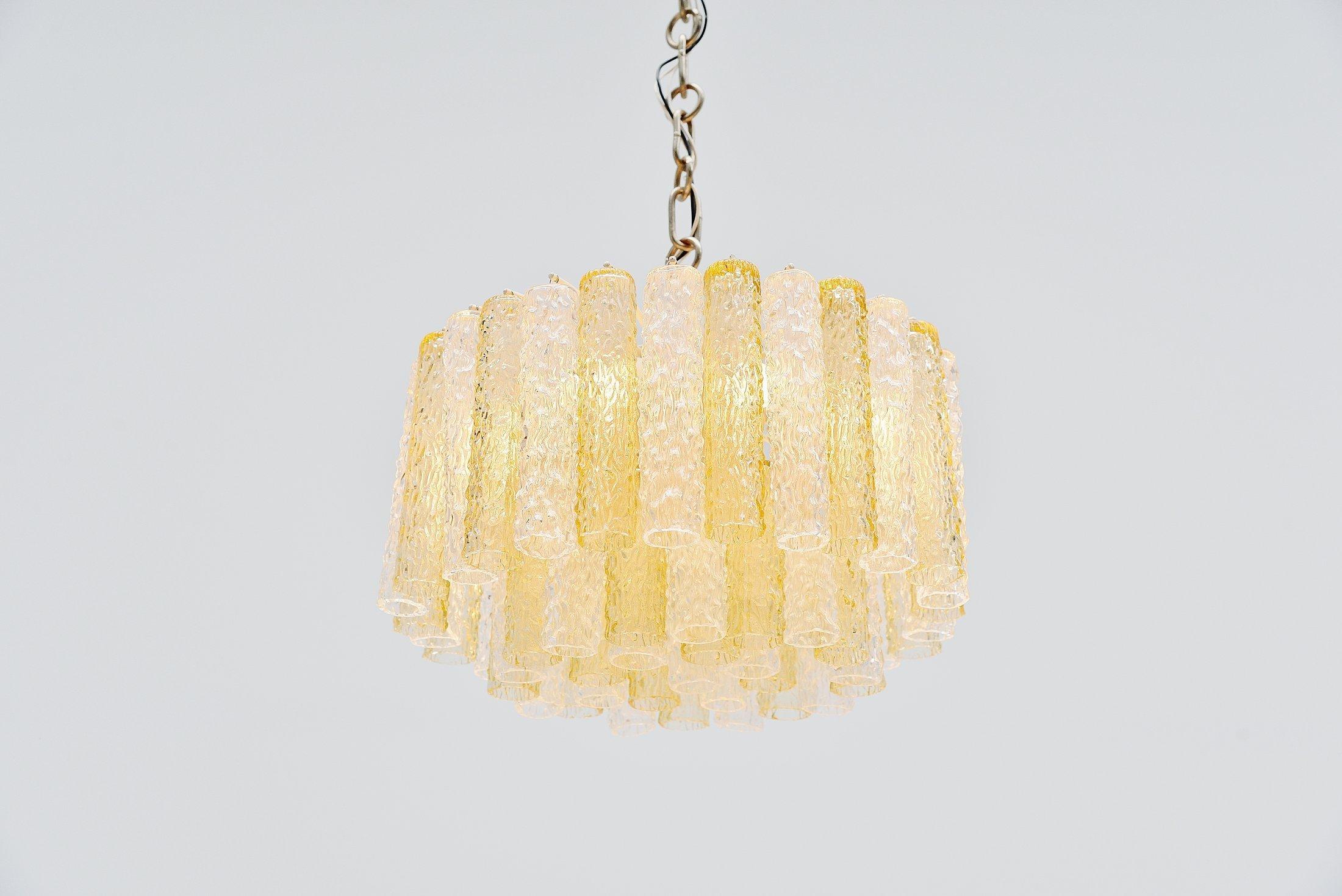 Fantastic chandelier designed by Paolo Venini and manufactured by Venini, Murano Italy 1960. This chandelier has 55 ice look glass tubed pegs in clear and yellow glass hanging on a white painted metal frame. The lamp uses 10x E14 bulbs up to 25