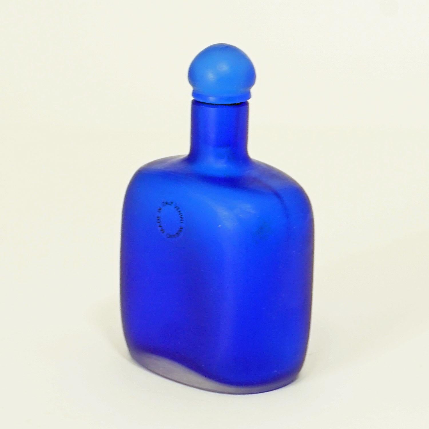 A great glass flacon designed by Paolo Venini in 1968, manufactured by Venini, Venice in 1992. Blue casted glass with incised surface, etched signature 'venini 92' on the base.

Measures: Width 3.35