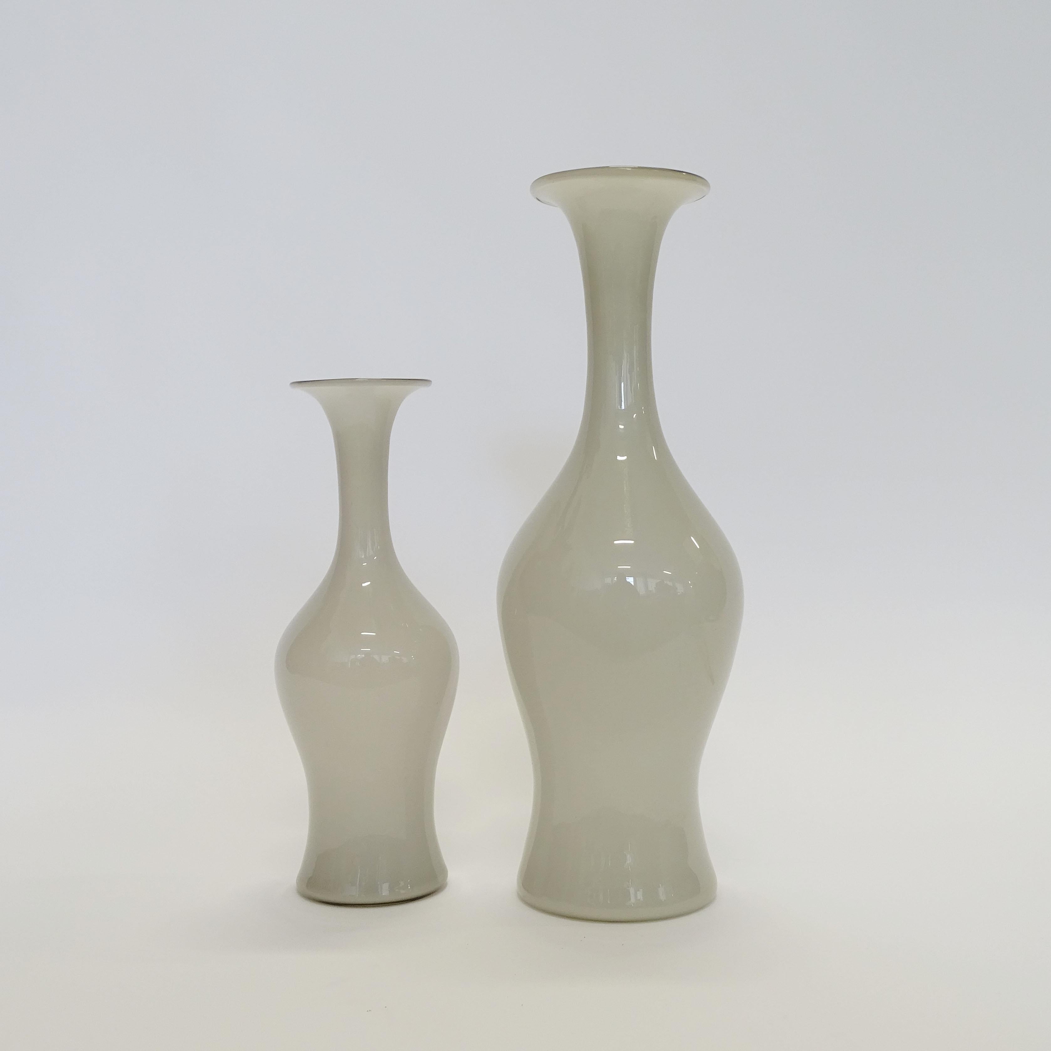 Monumental Paolo Venini vase model 3556 for Venini in light grey Opalino glass.
The second smaller vase measures Diameter 13 x H 38 cm.
Both vases carry the Venini label and are Acid etched Venini Murano Italia.
 