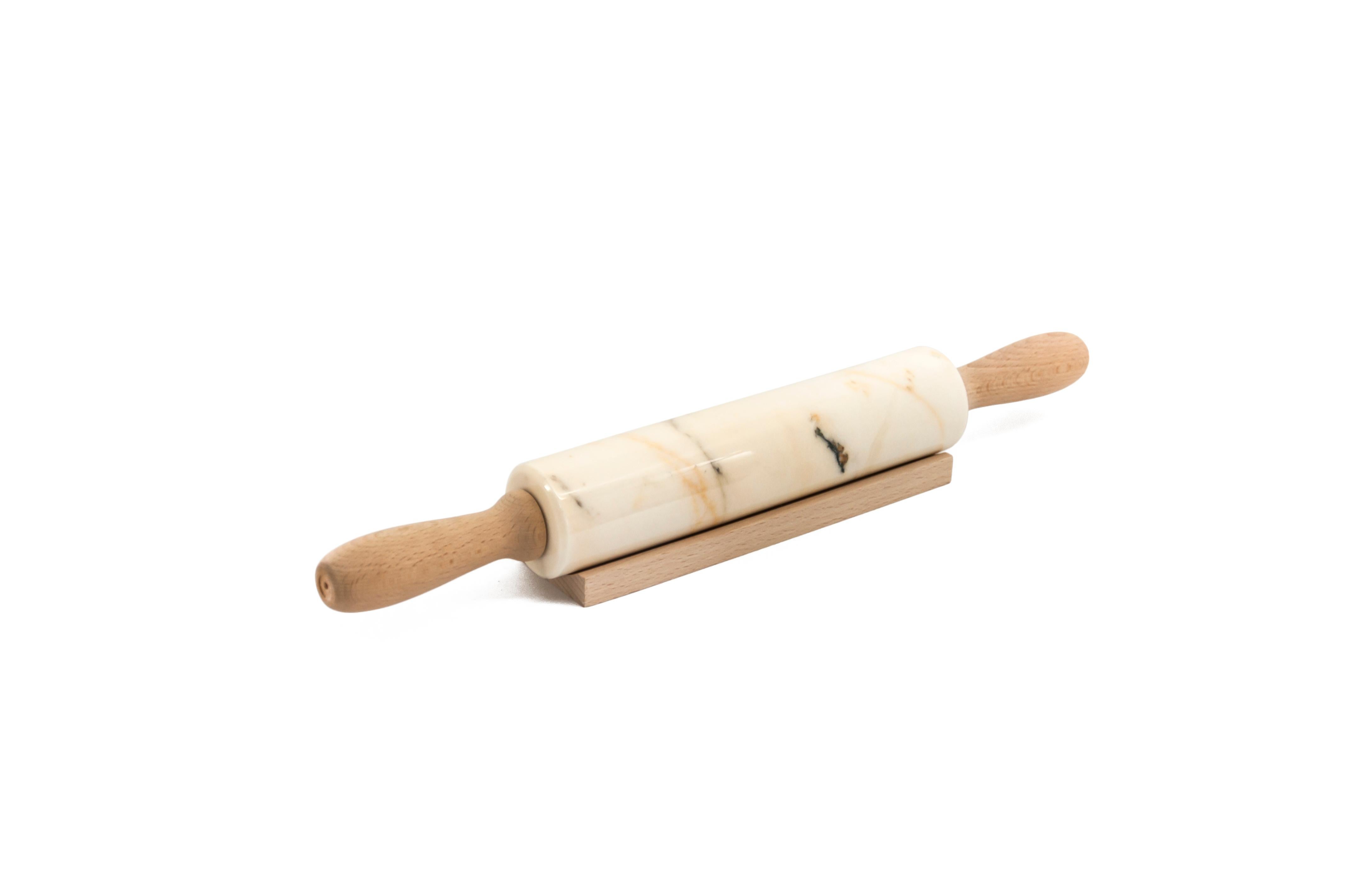 Paonazzo marble rolling pin with wooden handles. It is assembled manually. Each piece is in a way unique (every marble block is different in veins and shades) and handmade by Italian artisans specialized over generations in processing marble. Slight