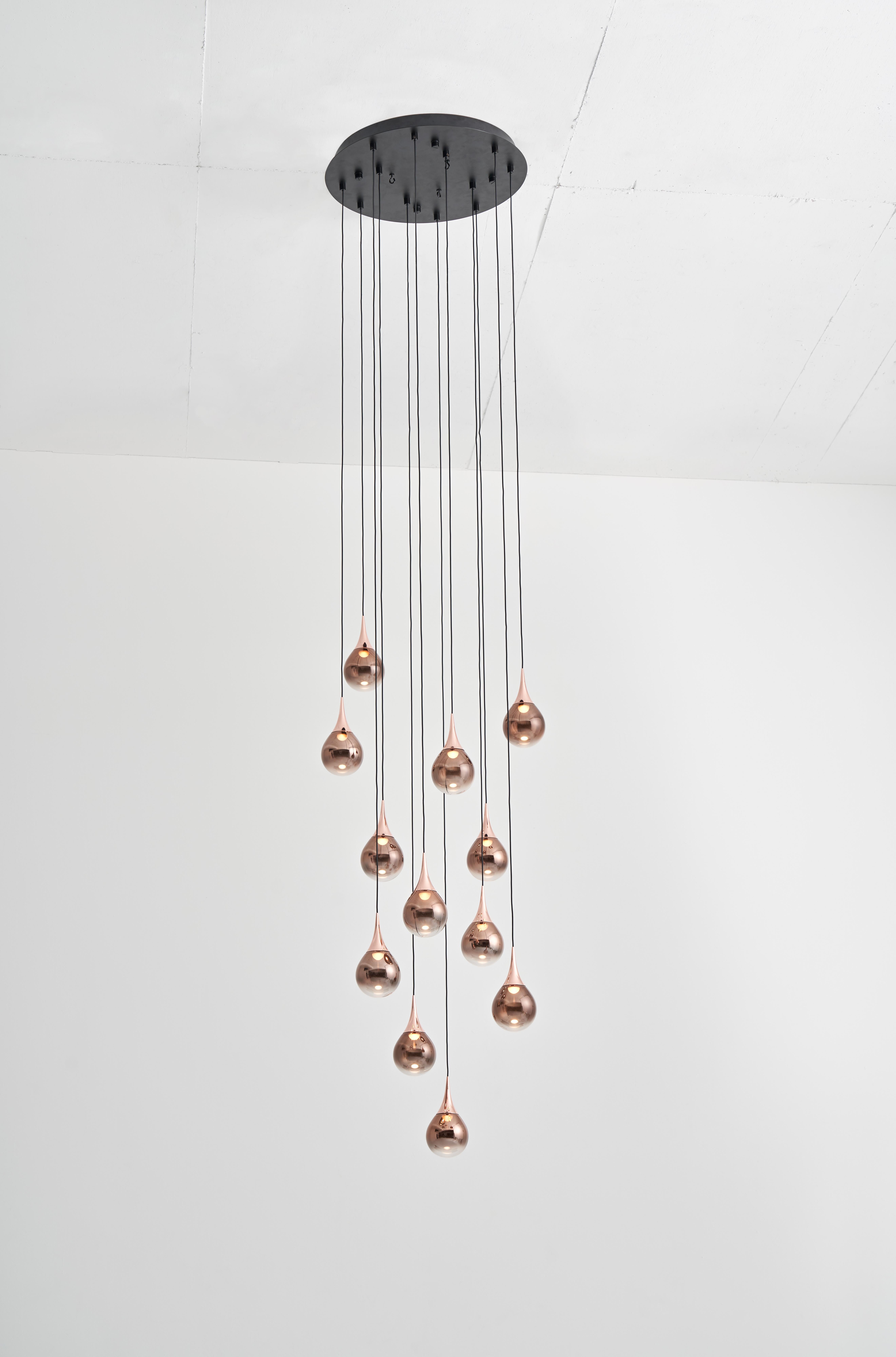 Inspired by artistry of fine jewelry, the PaoPao collection is available in three colorways, and multiple configurations. Each glass sphere of PAOPAO Pendant P12 is mouth-blown and vacuum plated to create a unique layered effect. The glass sphere