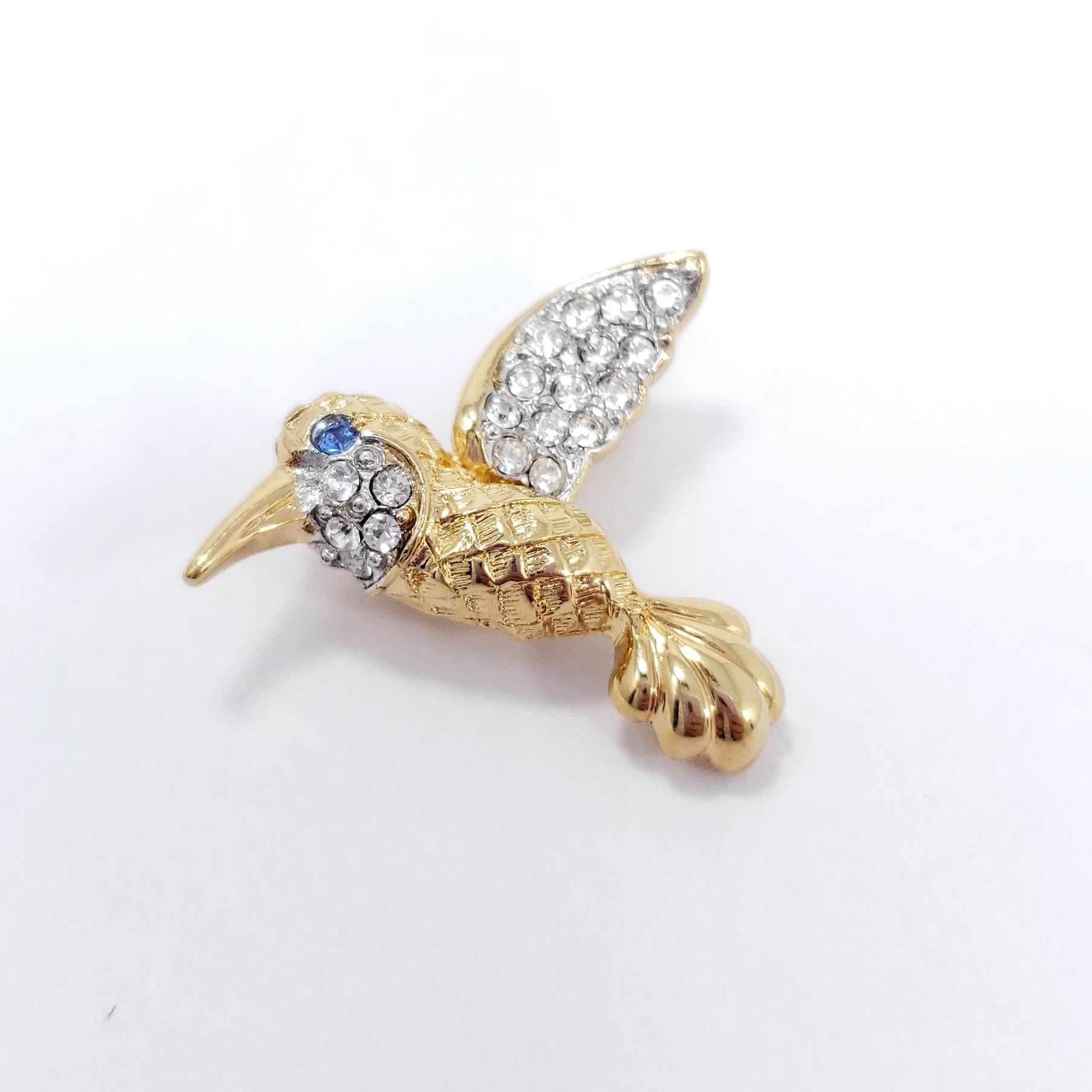 A stylish pin brooch by Pap, featuring a gold-plated hummingbird decorated with sparkling crystals.

Hallmarks: Pap