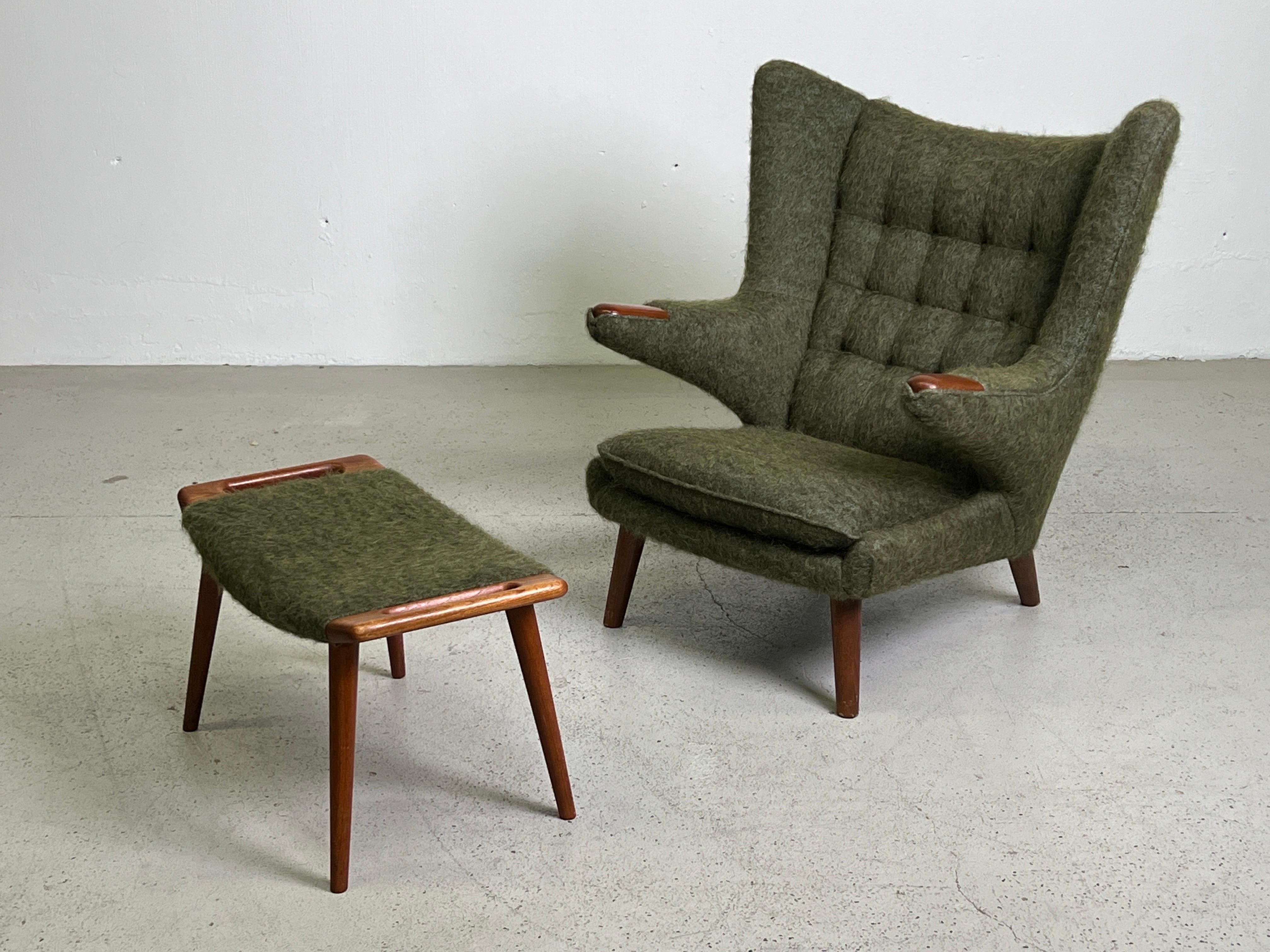 A beautifully restored Papa Bear chair and ottoman in teak by Hans Wegner for A.P Stolen. Reupholstered in Pierre Frey / YETI / Sous Bois fabric. 