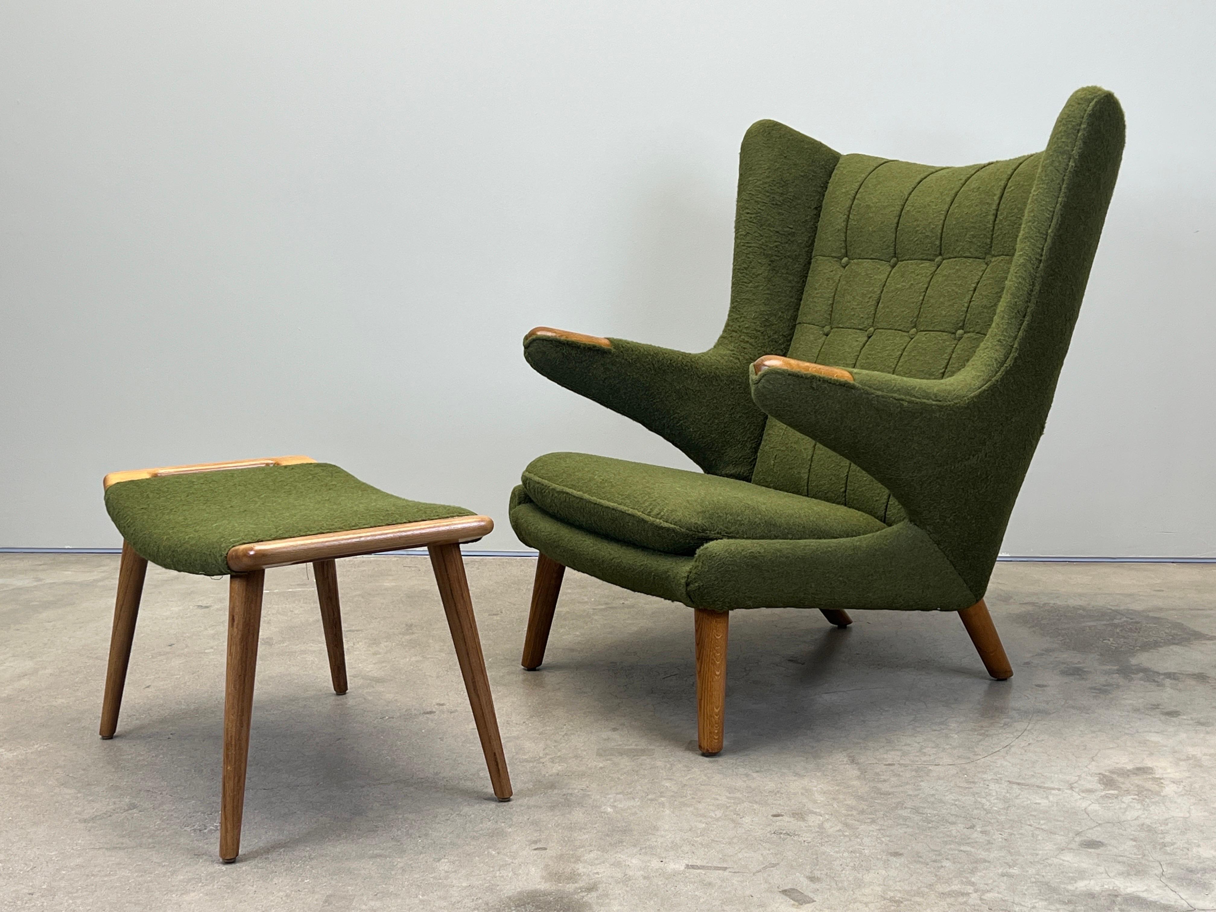 A beautifully restored Papa Bear chair and ottoman in oak, designed by Hans Wegner for A.P. Stolen. Upholstered in Holly Hunt / Hembra / Palm. 