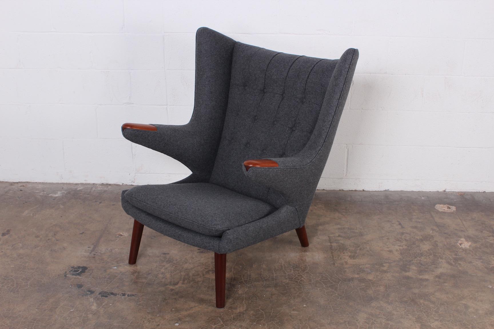 A fully restored Papa bear chair designed by Hans Wegner for A.P Stolen. Reupholstered in Maharam wool.