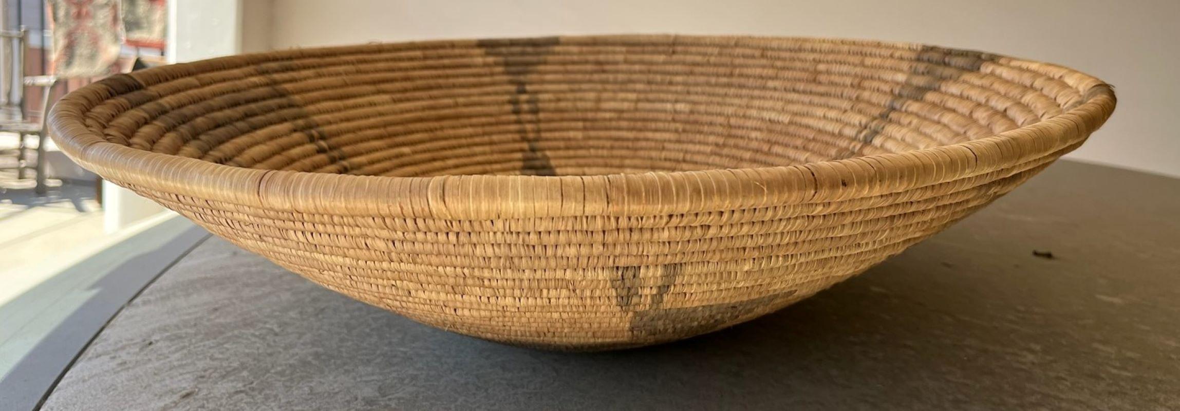 Hand Made mid-century Papago basket with animal and people pictorail motif that show on the interior and exterior of the basket. The basket is mad from devils grass and is in great condition.