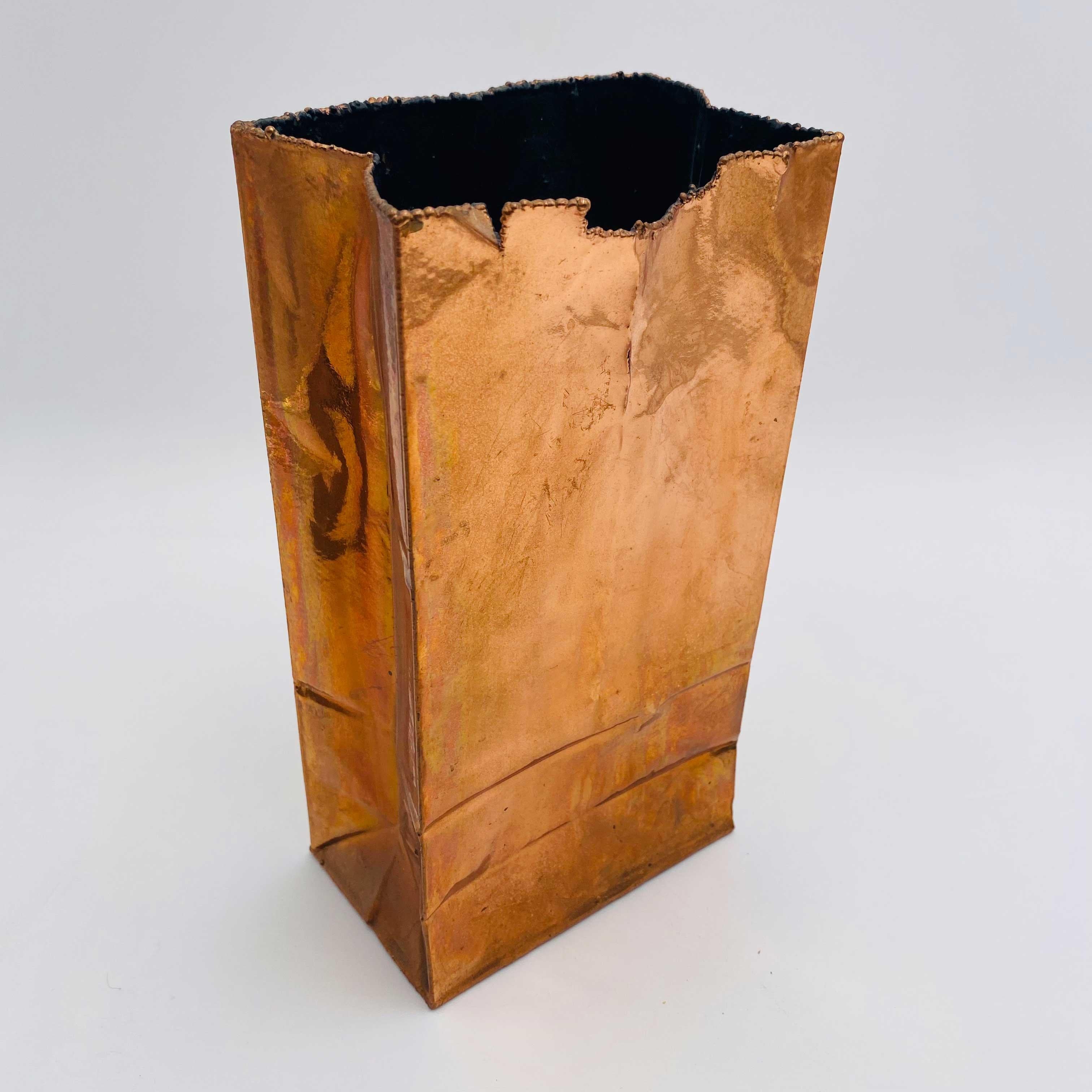 Copper-colored paper bag vase sculpture made from metal by California Bronze, Sonora, CA. The maker's mark sticker is still intact on the bottom of the piece. A similar style to the Rosenthal Paper Bag Vase by Tapio Wirkkala. A decorative piece that