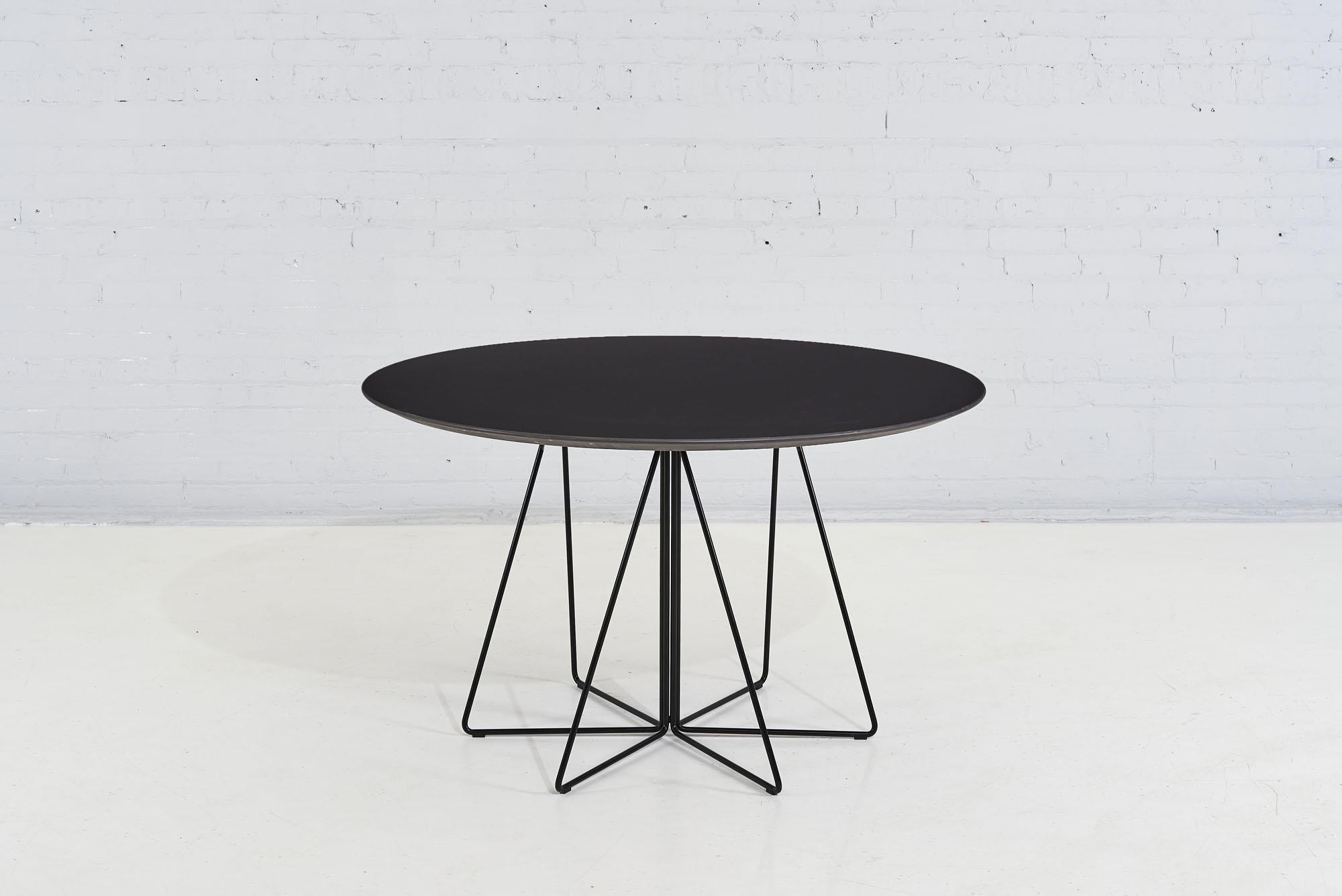 Paper clip dining table by Vignelli designs for Knoll, 1994. Black laminate knife edge table top with black metal base.