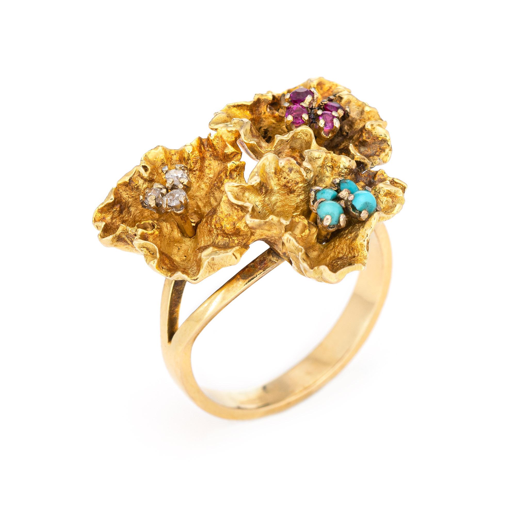 Stylish vintage paper flowers gemstone ring (circa 1960s to 1970s) crafted in 18 karat yellow gold. 

Diamonds total an estimated 0.03 carats (estimated at H-I color and SI1-I1 clarity), accented with an estimated 0.04 carats of rubies and 0.04
