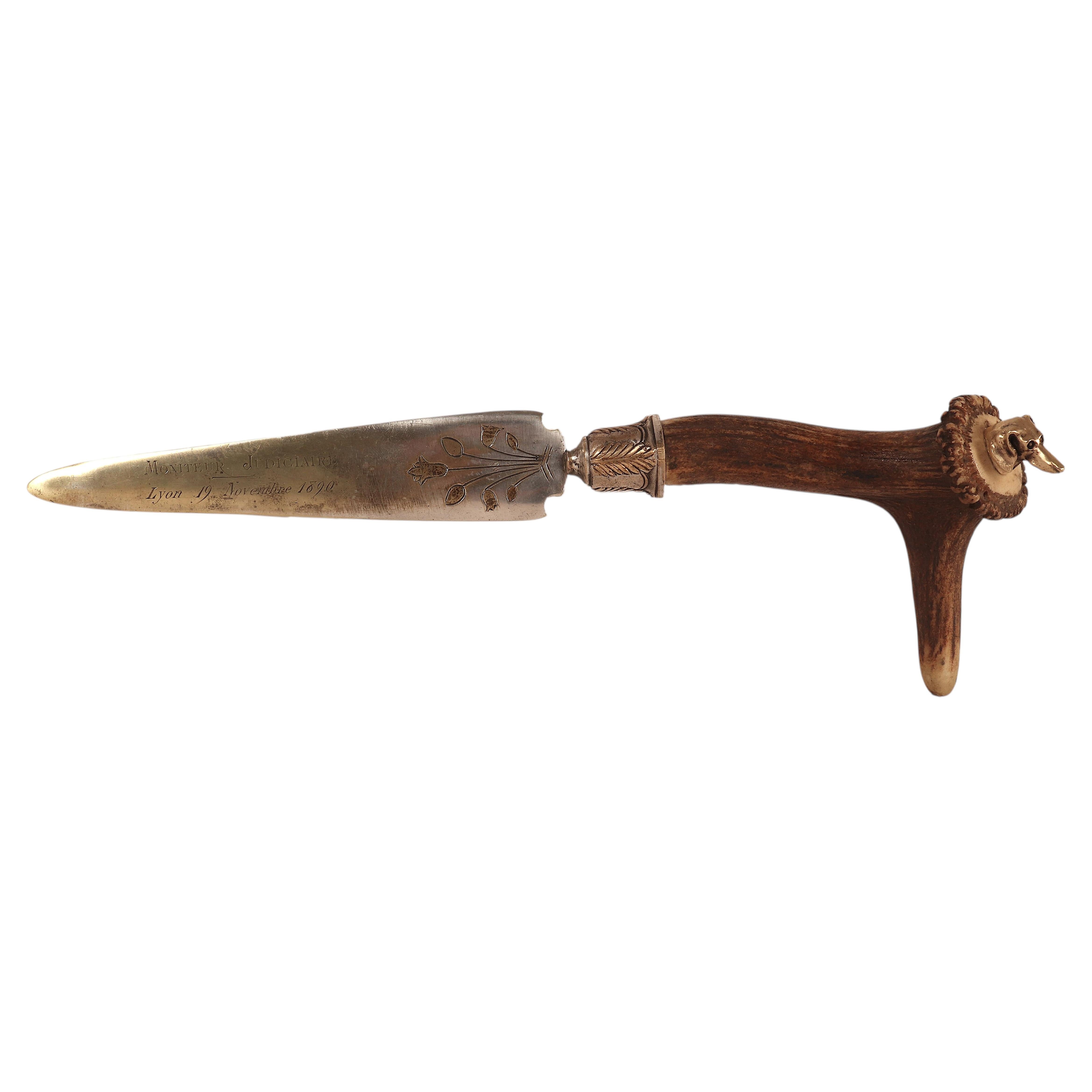 Paper knife, brass blade, stag horn handle with dachshund dog head. France 1890.