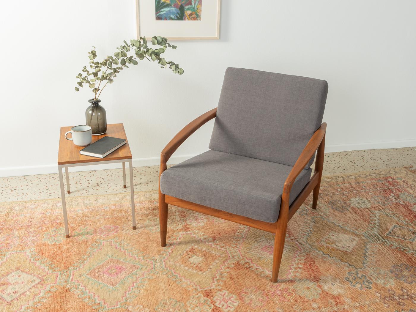 Paper Knife Chair by Kai Kristiansen for Magnus Olesen from the 1950s. High-quality frame in teak. The armchair has been reupholstered and covered with a high-quality fabric in grey.

Quality Features:
 accomplished design: perfect proportions