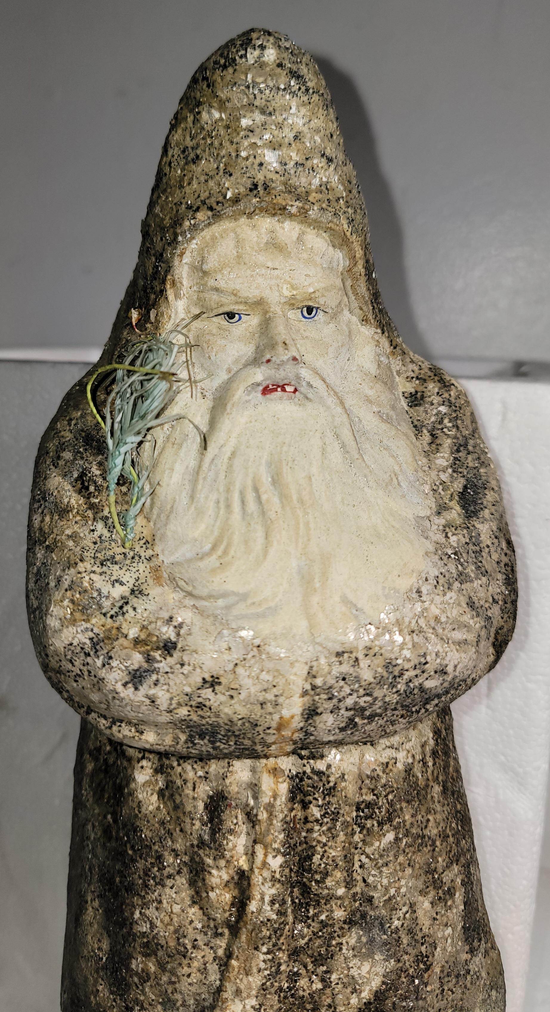 Belsnickel from Germany in fine condition with glider body minor piece missing of back of robe.The face is amazing & father Christmas is holding a small feather tree,