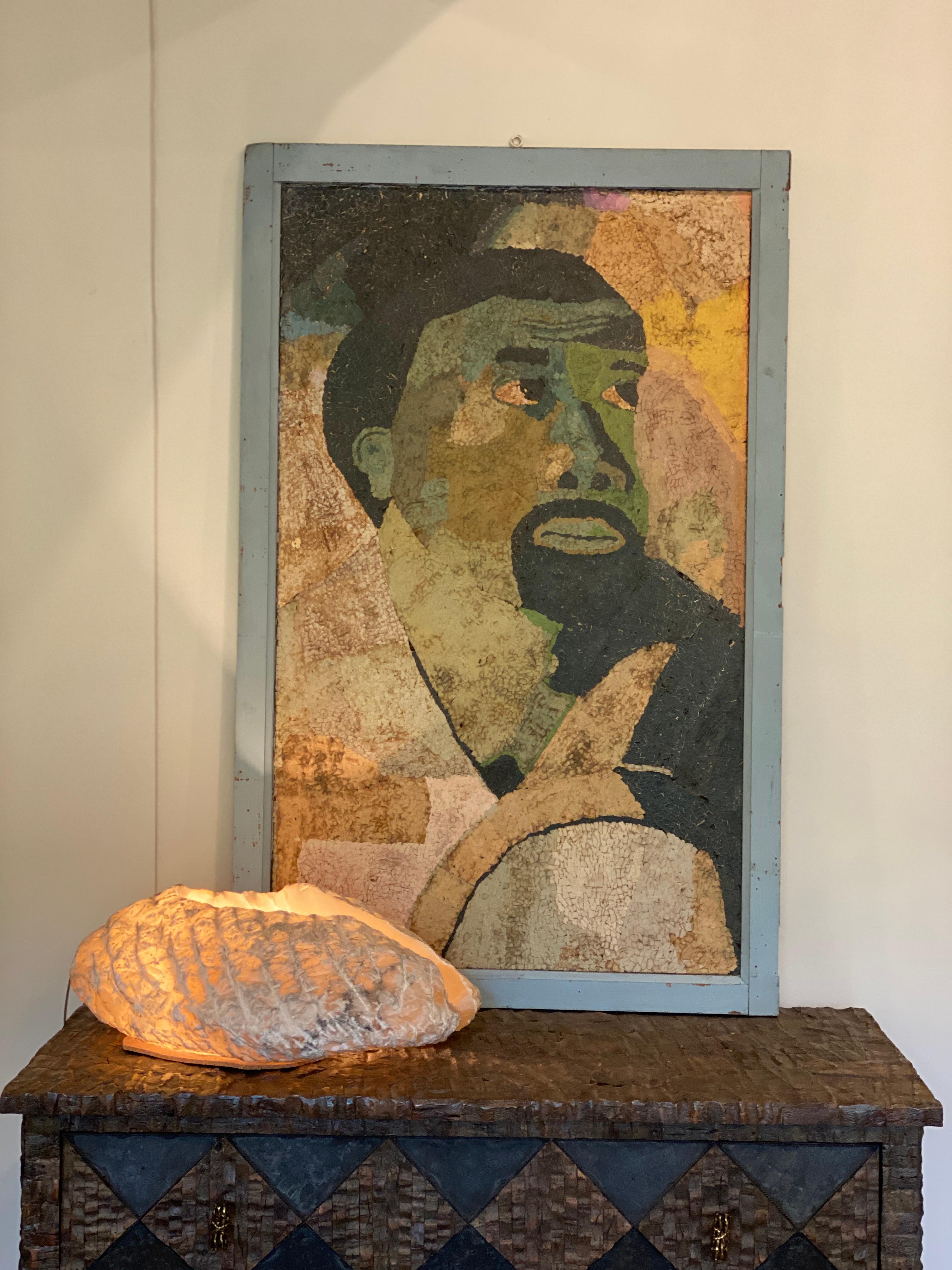 A fascinating collage on board paper mosaic. The composition of minuscule pieces of paper creates a figurative portrait of a male torso; a beautiful representation of Black afro art. From the early to mid-20th century with age and patina that adds