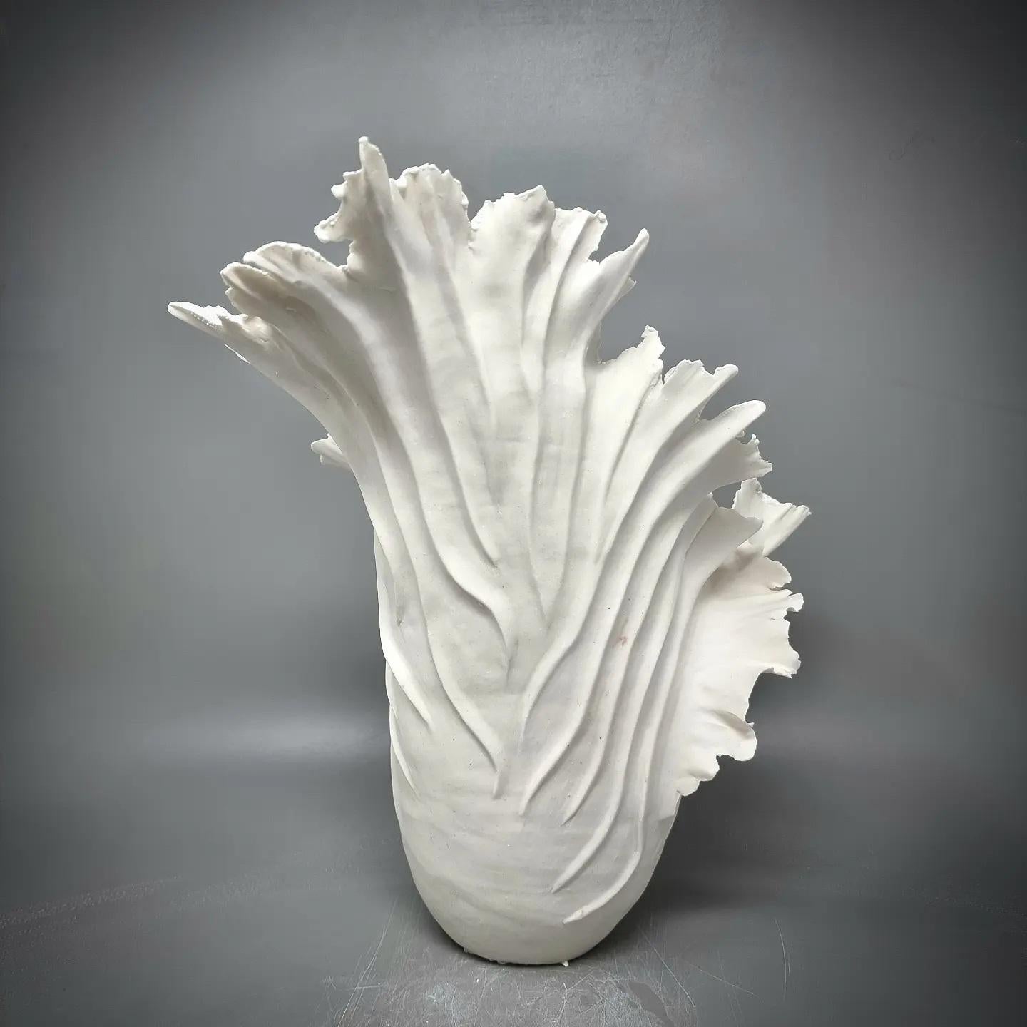 Handbuilt Stonewear Sculpture in paper porcelain. 

The inside is glazed with white diamond glaze. 

It is sculpted by hand, slowly adding coils and clay to create the final result. This is a piece of art based on classic sculpting methods.