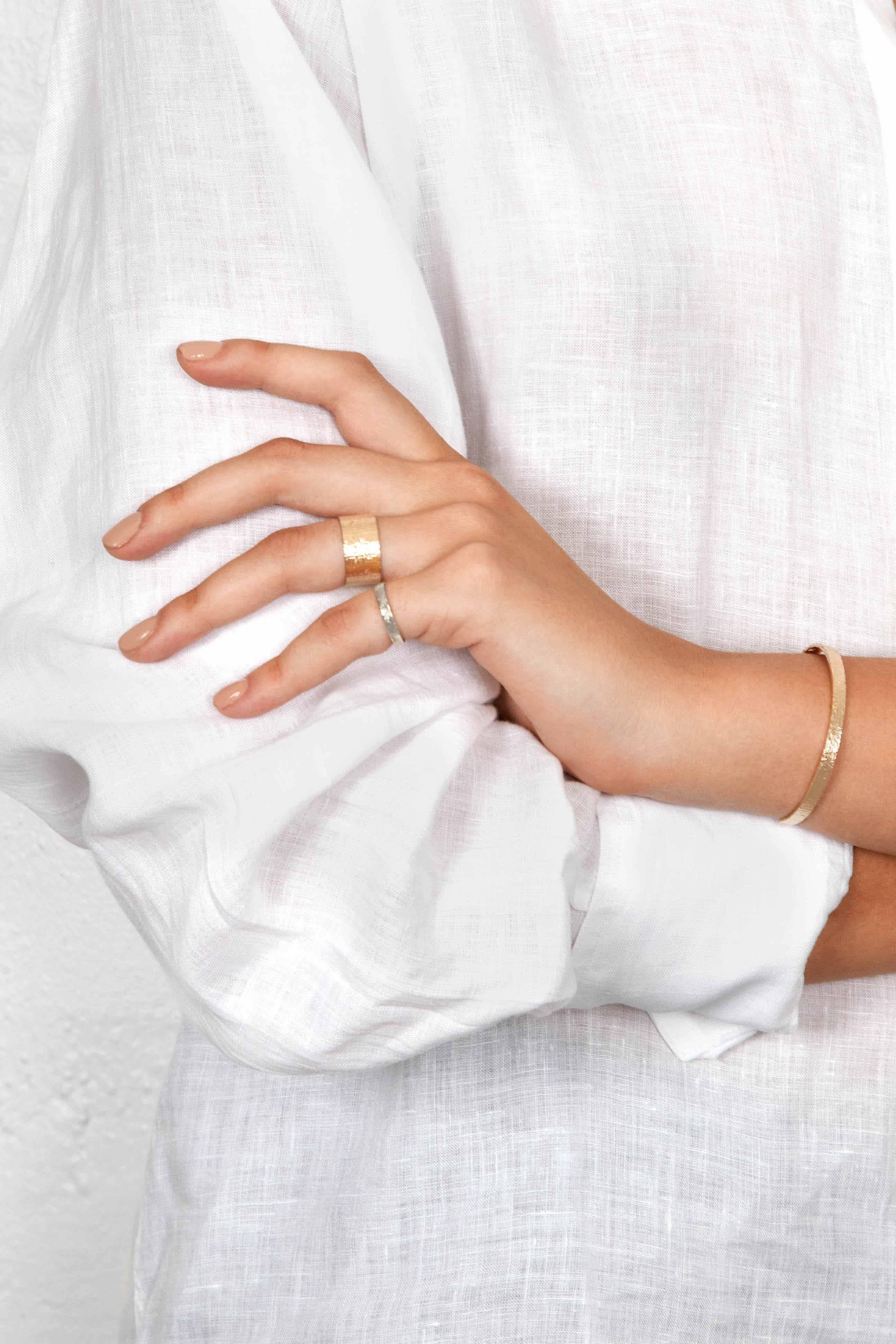 This classic cuff bracelet is handcrafted in solid 18-carat gold with a shimmering rustic texture.

Every piece in this collection is individually hand-crafted in paper and cast directly into precious metal in a unique and innovative process.  Every