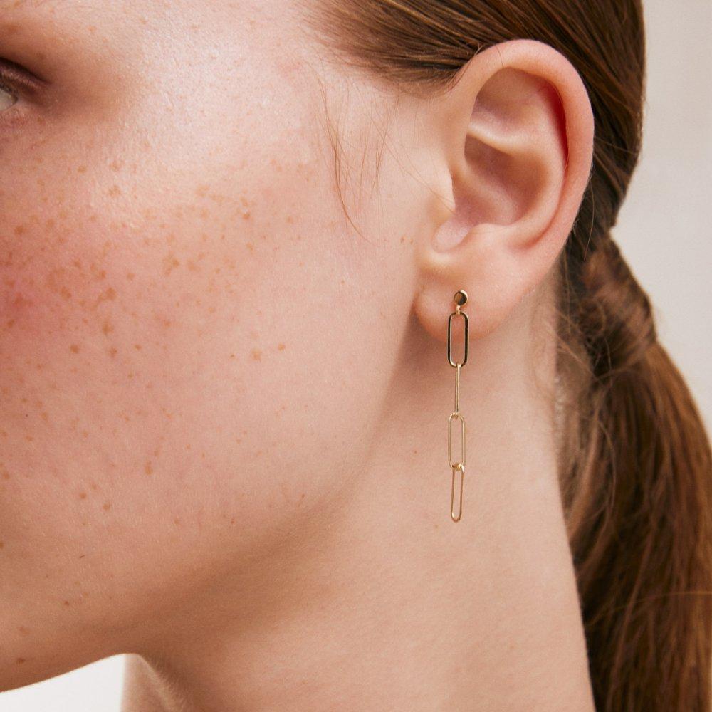 Introducing the 14K Solid Gold Dainty Paperclip Chain Drop Earrings, an embodiment of Orena Jewelry's passion for fine craftsmanship and elegant design. Each earring is meticulously handcrafted, a fusion of minimalist style and the intrinsic value