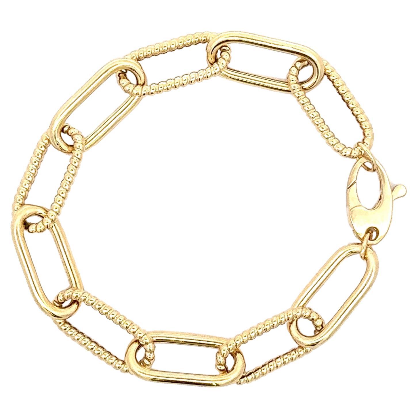 Paper clip bracelet with a twist & high polish alternating motif links weighing 6.6 grams, in 14 karat yellow gold.

Link Measurements: 
19.6 MM x 9 MM