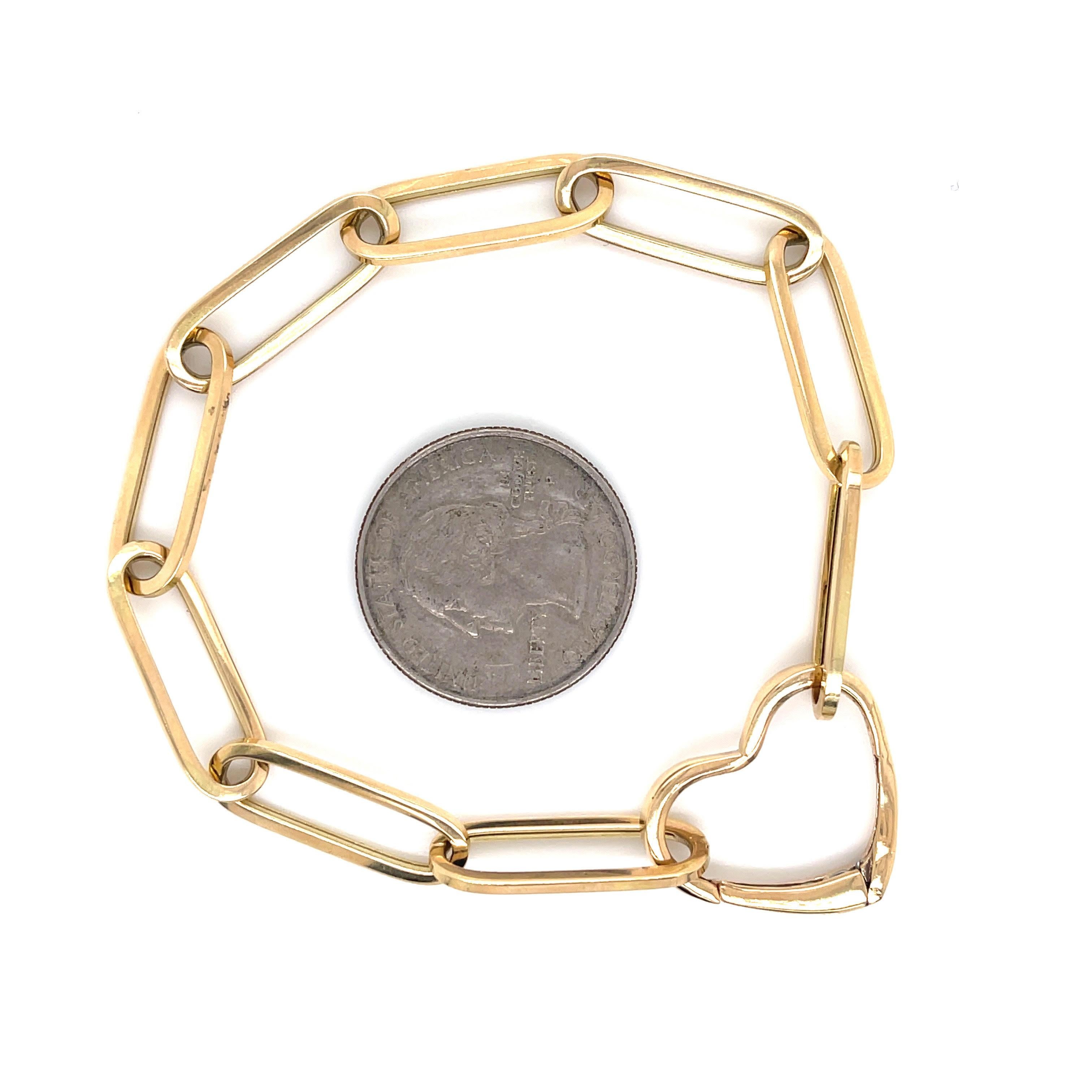 Bracelet trombone en or jaune 14 carats avec fermoir en forme de cœur. Le fermoir peut être retiré et mis sur un collier avec des charmes.

7.5