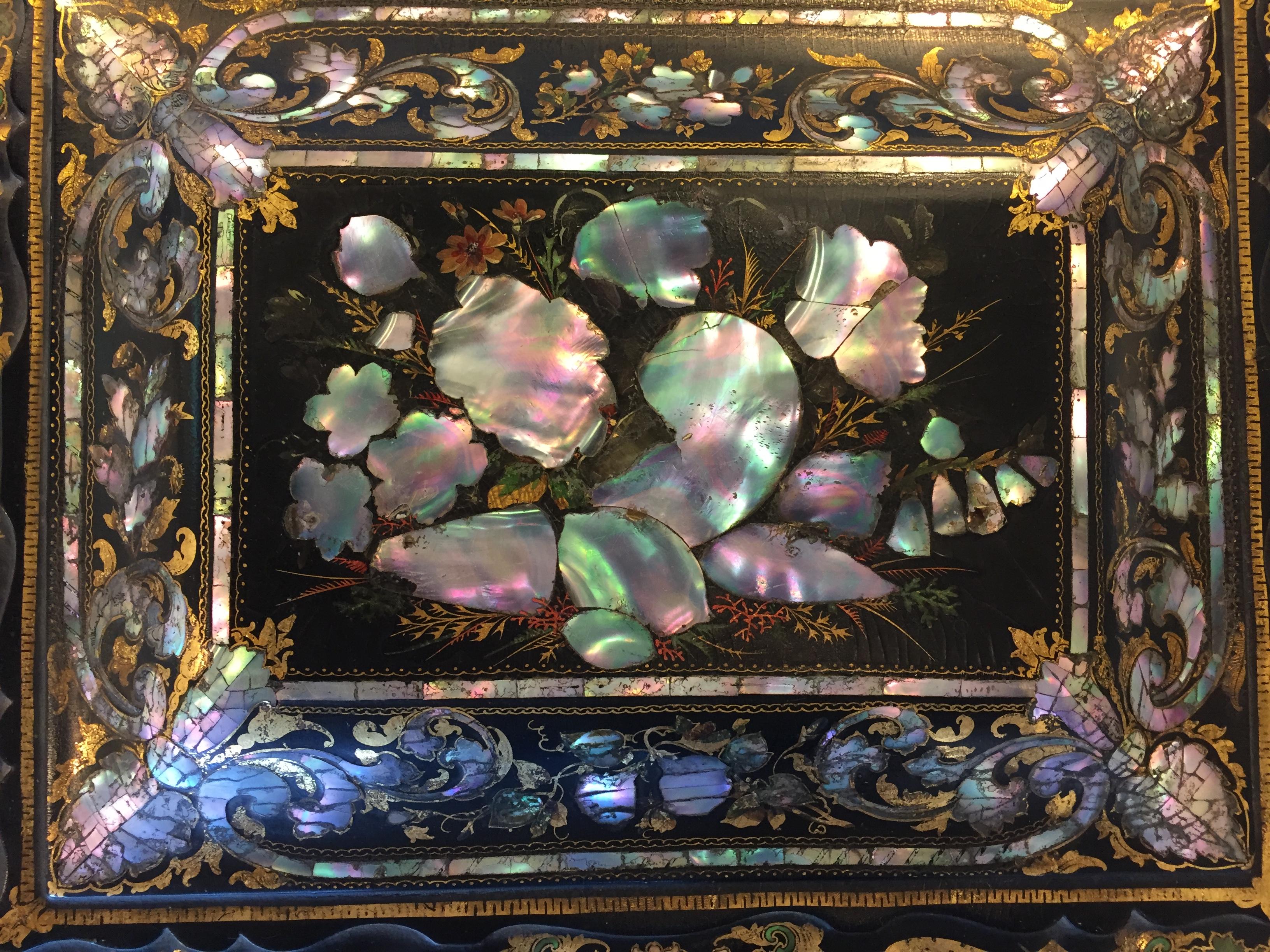 Papier mâché circa 1870 English inlaid lacquered sewing box/jewelry box, with many Velvet and mother-of-pearl compartments, hidden area in center. Hand-carved mother-of-pearl, inlaid with abalone gold leaf hand-painted and embellished decoration.