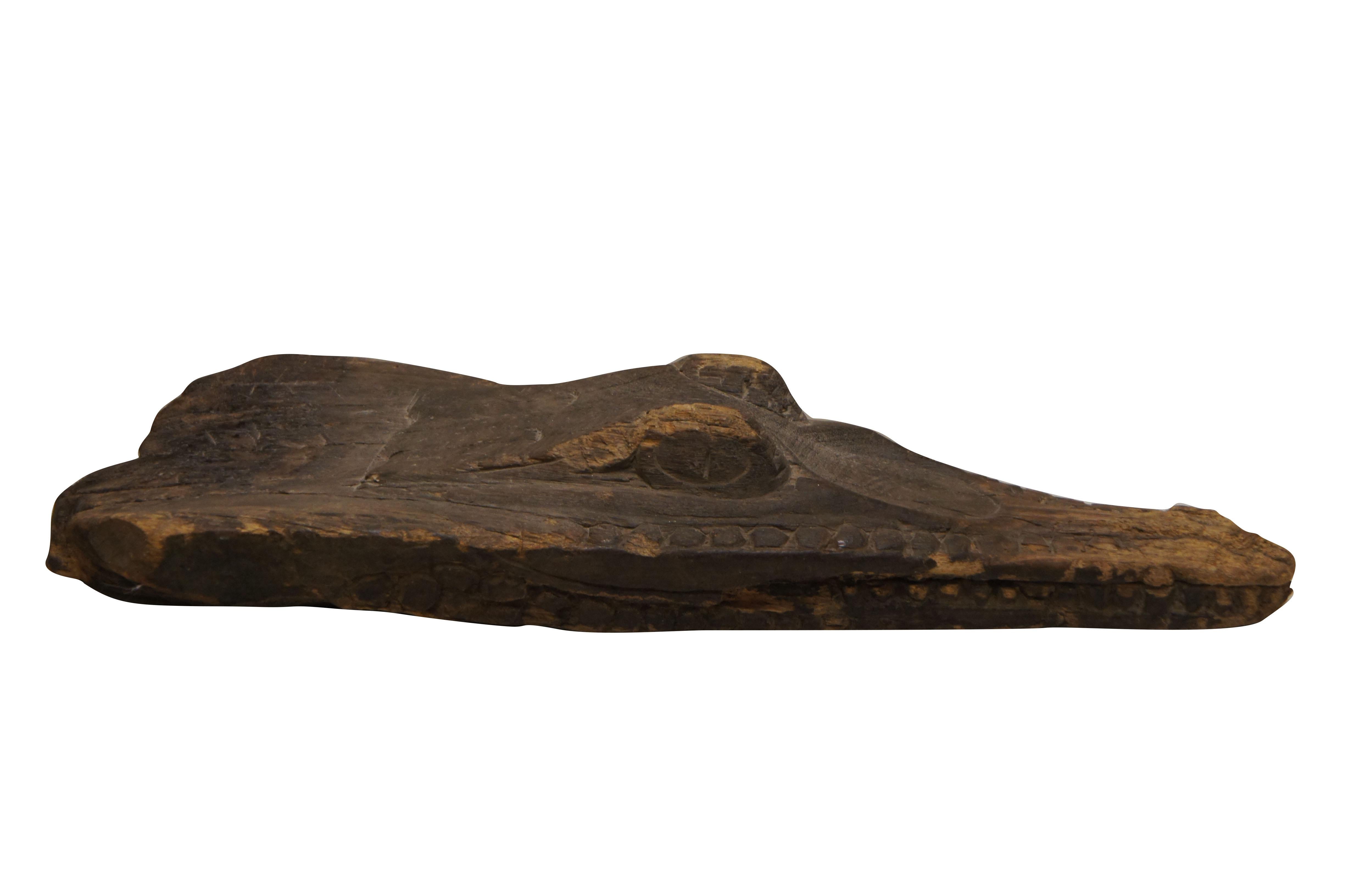 An impressive mid 20th century crocodile/alligator head boat prow. Carved from driftwood with meticulous detail. Villagers in Papua New Guinea adorned their boats and canoes with alligator prows as they traveled through inland rivers and swamp land.