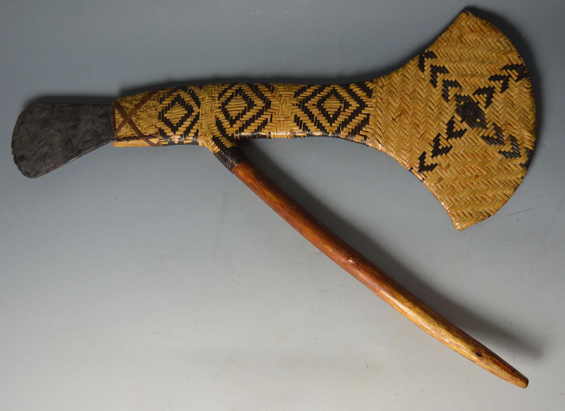 Large Exquisitely crafted  Oceanic Presentation Axe 
Papua New Guinea  Eastern Highlands  Wahgi Valley  Mount Hagen region.
 
Mount Hagen ceremonial axe,   woven rattan, bicoloured in geometric patterns; the wooden handle attached at an angle with a