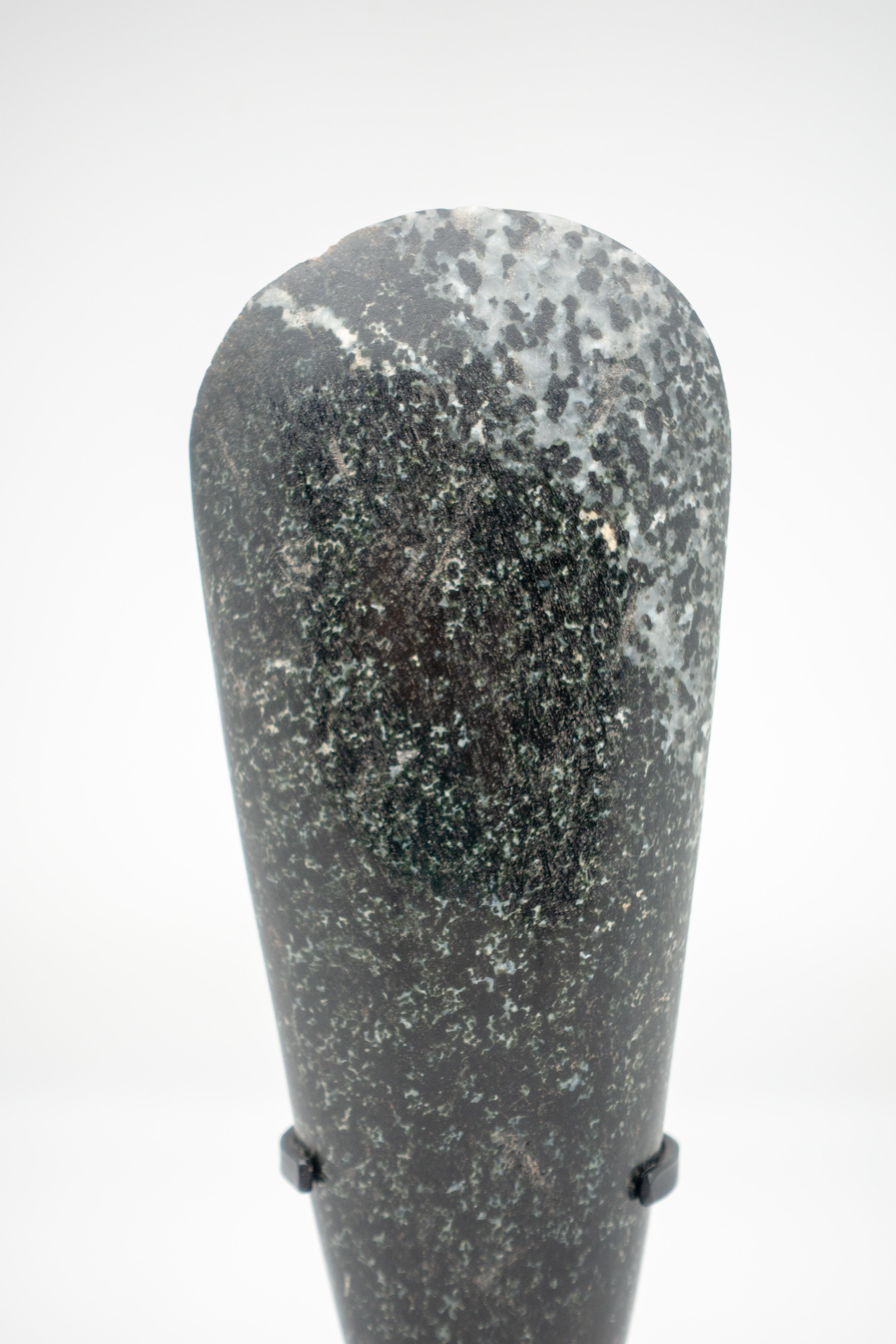 Stone axehead from Papua New Guinea mounted on a custom black steel base.