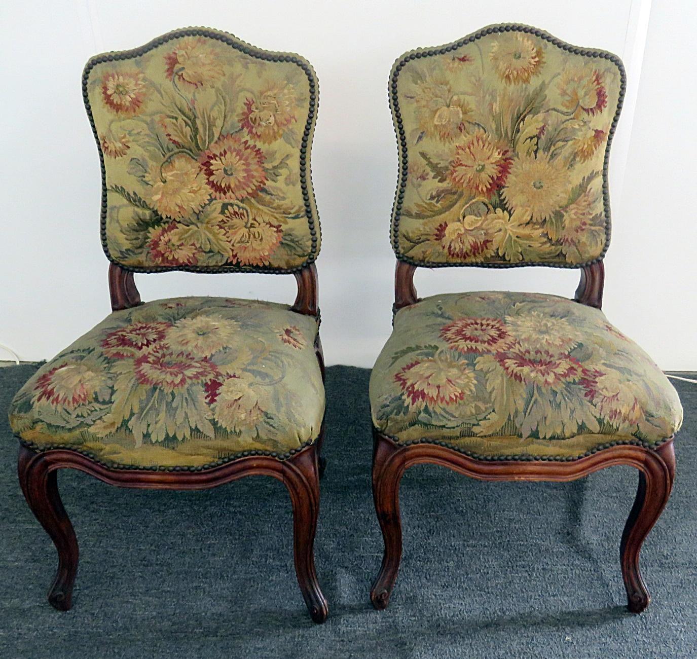 Pair of Louis XVI style side chairs with needle point upholstery and nail head trim.