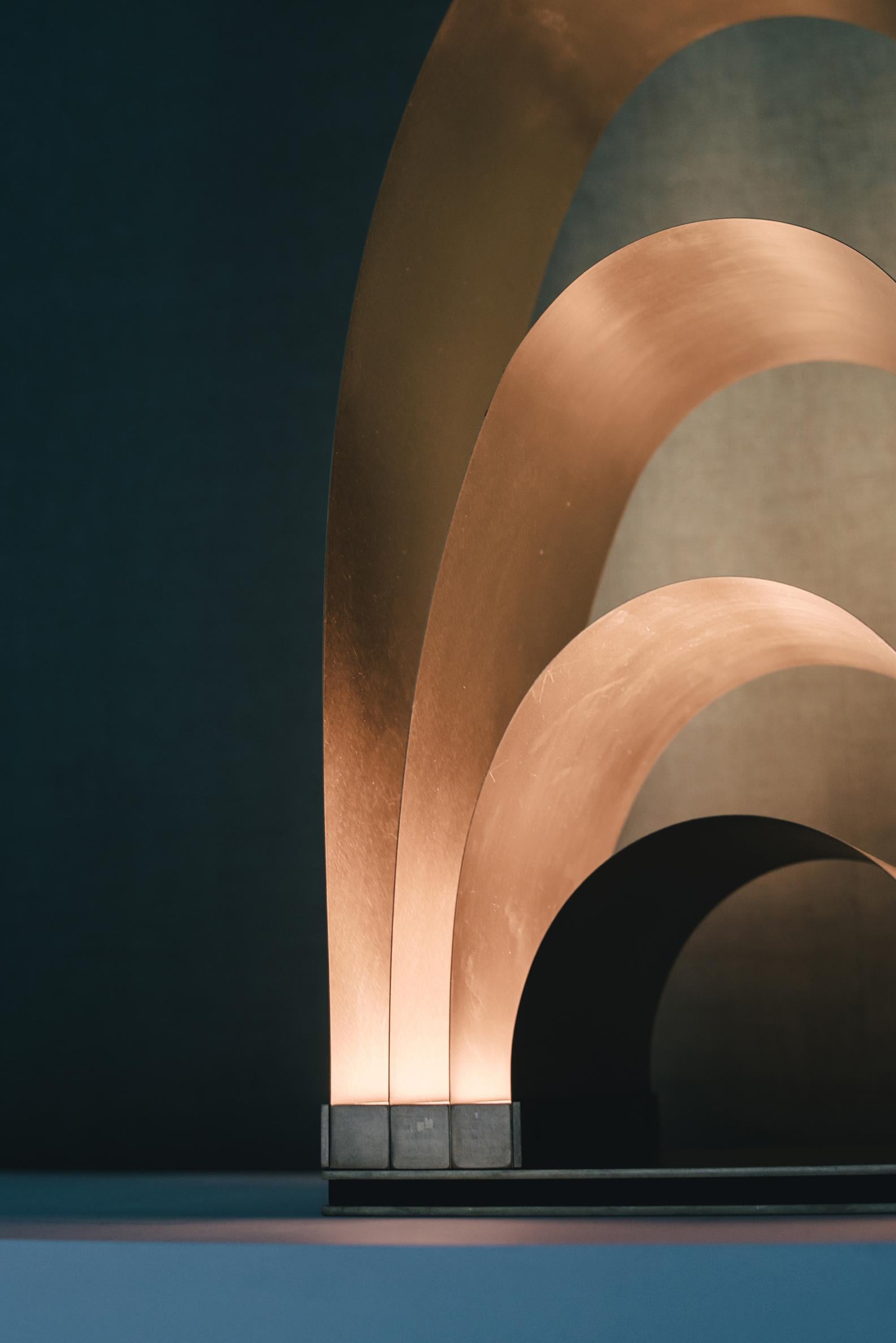 Parabola III is a Layers Floor Lamp specially designed for reflection based on how the light travels through a solid surface, the beginning and the end, the darkness, the gloom to the dawn, on tension and flexion. The starting points where the brass