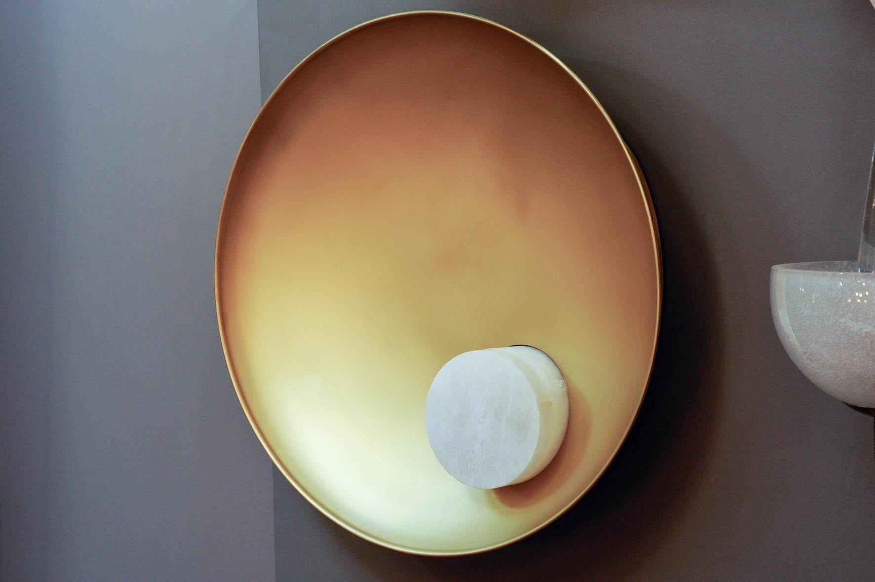 New wall sconces design, concave brass plate with an alabaster cylinder built in it.

 