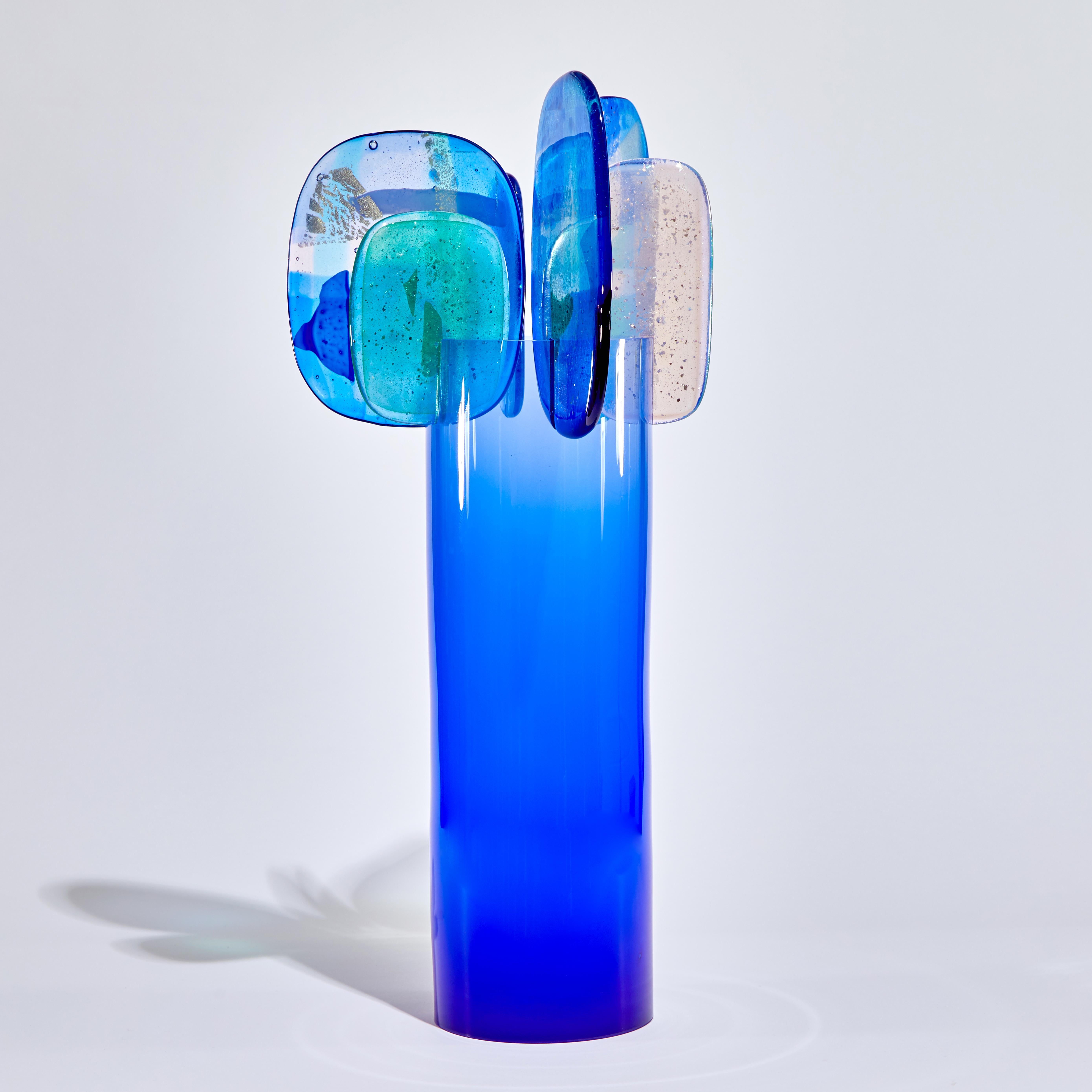 'Paradise 01 in Cobalt' is a unique glass sculpture created using hybrid hand-made glass techniques by the British artist Amy Cushing. Combining mouth blown glass with kiln formed glass, each piece within the collection displays a multiple of highly