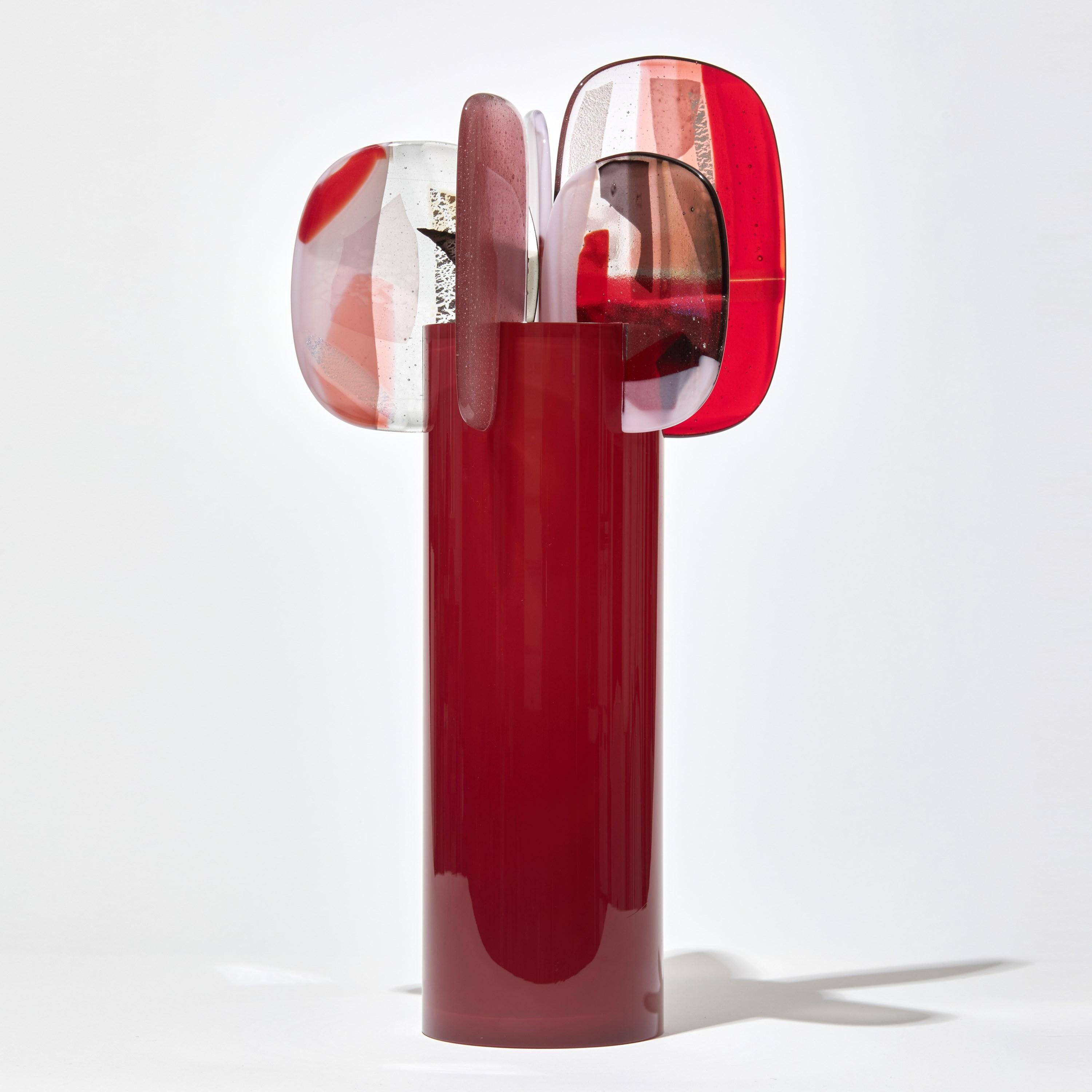 'Paradise 04 in Ruby' is a unique glass sculpture created using hybrid hand-made glass techniques by the British artist Amy Cushing. Combining mouth blown glass with kiln formed glass, each piece within the collection displays a multiple of highly