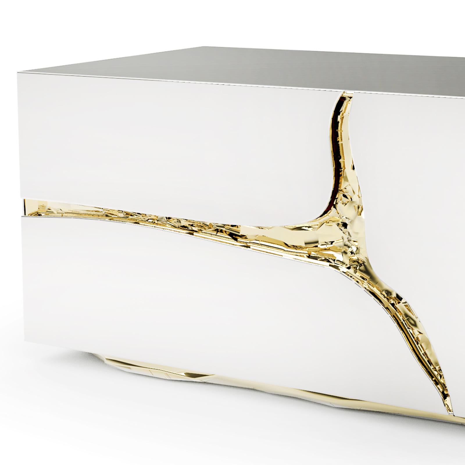 Nightstand or side table with poplar root veneer
structure inside and covered with polished stainless 
steel. With carved details in hammered brass. With
2 drawers and with blackened glass top.