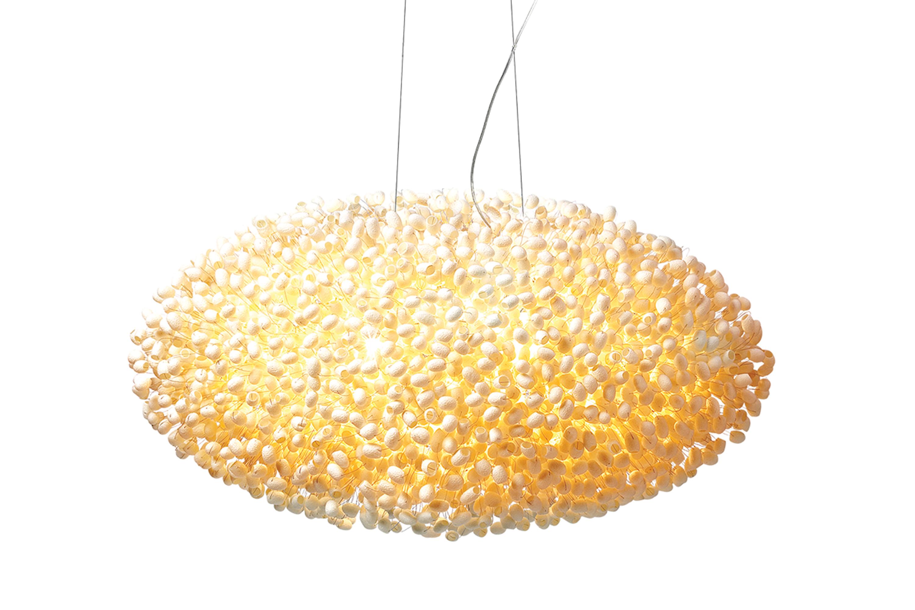 For Paradise pendant lighting design, the miracle of each silk cocoon being formed by its creator is taken and exploited to the full by illuminating it from within with two light sources.

In Paradise, we build up a hand welded steel structure (each