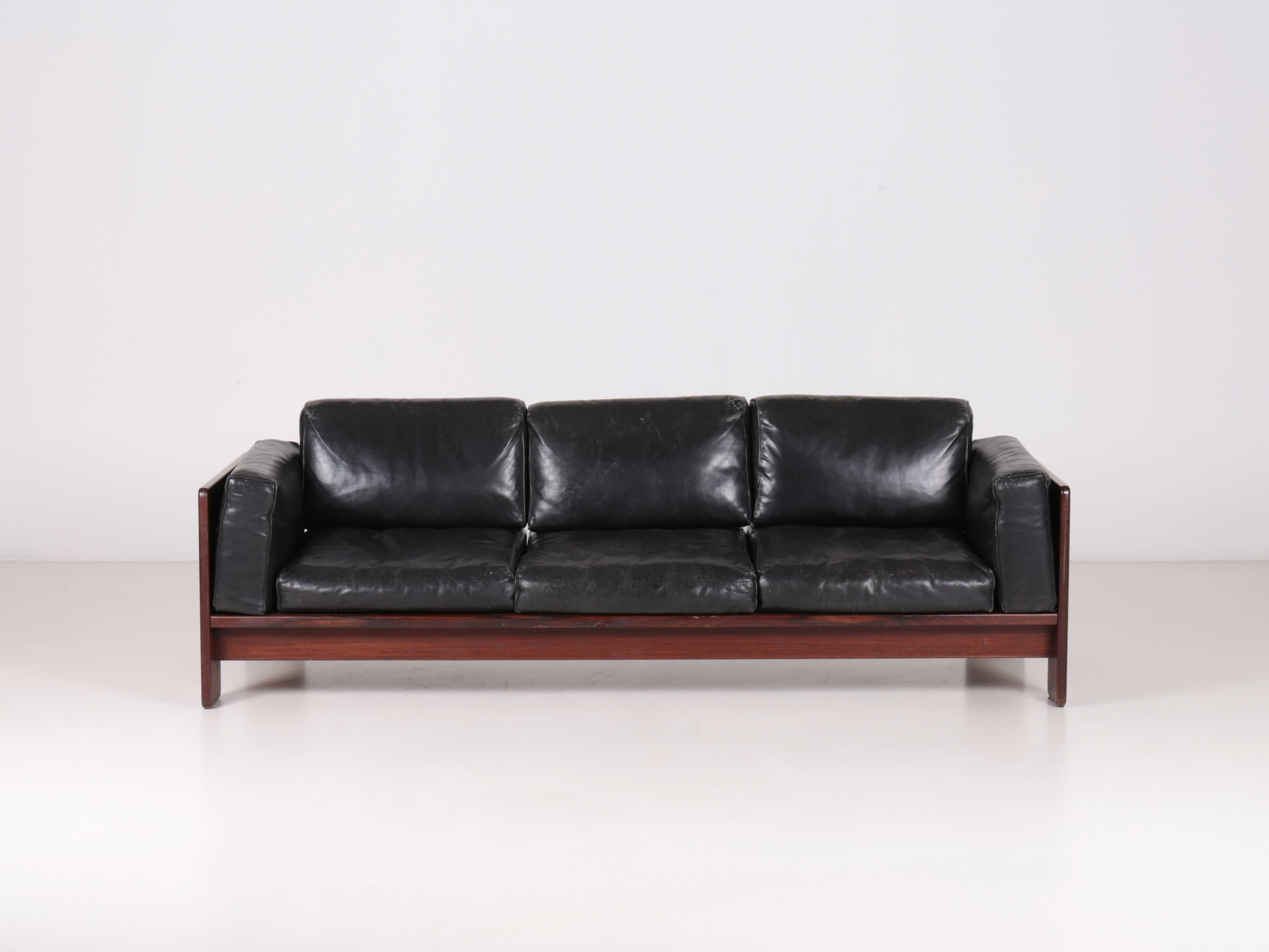 Supporting structure in rosewood. Flying cushions with polyurethane bottom and top in feather on covered steel elastic straps. Original upholstery in leather. A simple wooden frame for a leather “classic sofa” which no longer needed an upholsterer