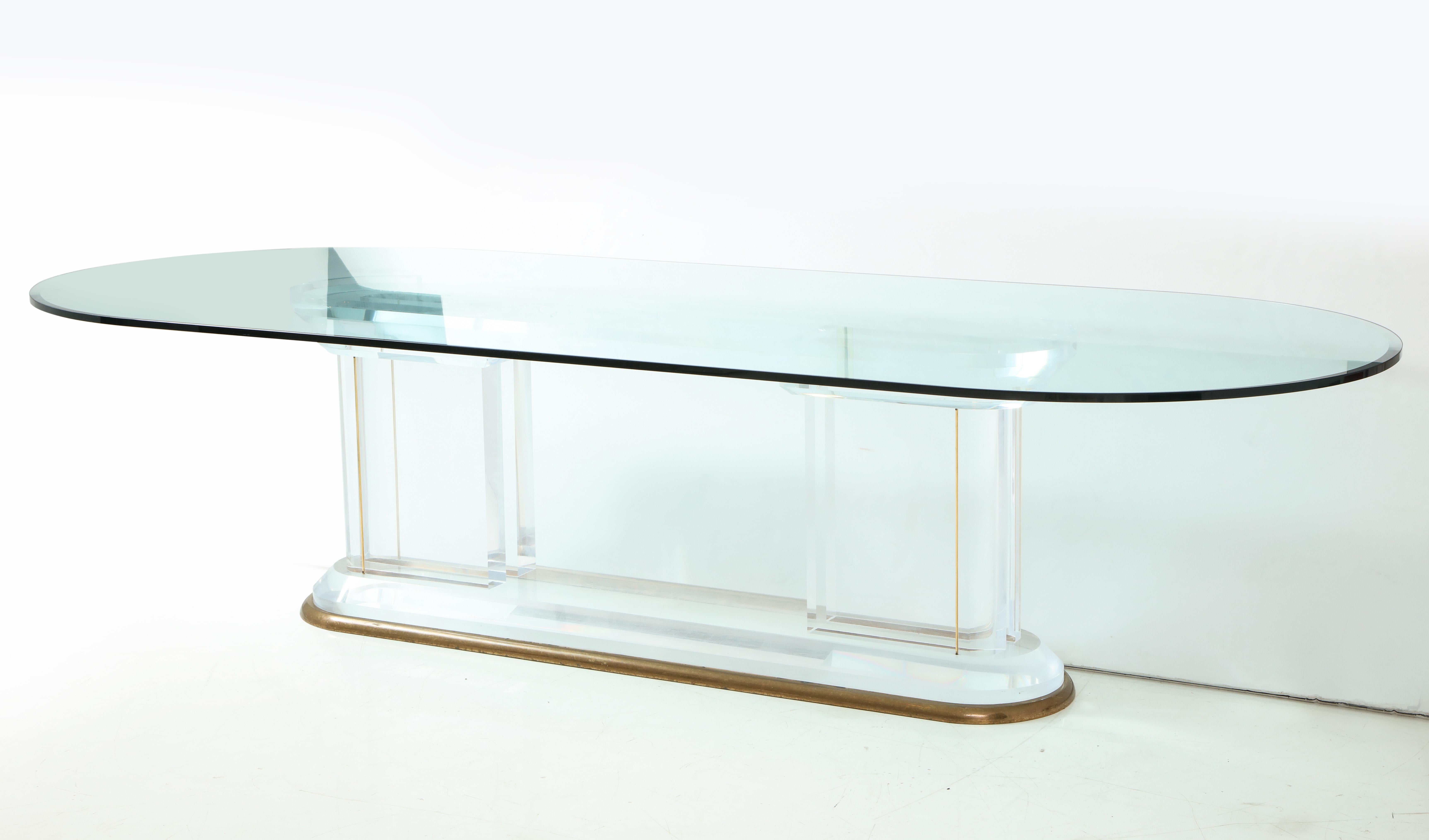Spectacular AH Paragon dining table by Jeffrey Bigelow signed 1987.
Classical influenced Lucite columns on a bronze race track base which has a beautiful patina creates a stunning minimalist dining table.
The table supports a glass top which is 118