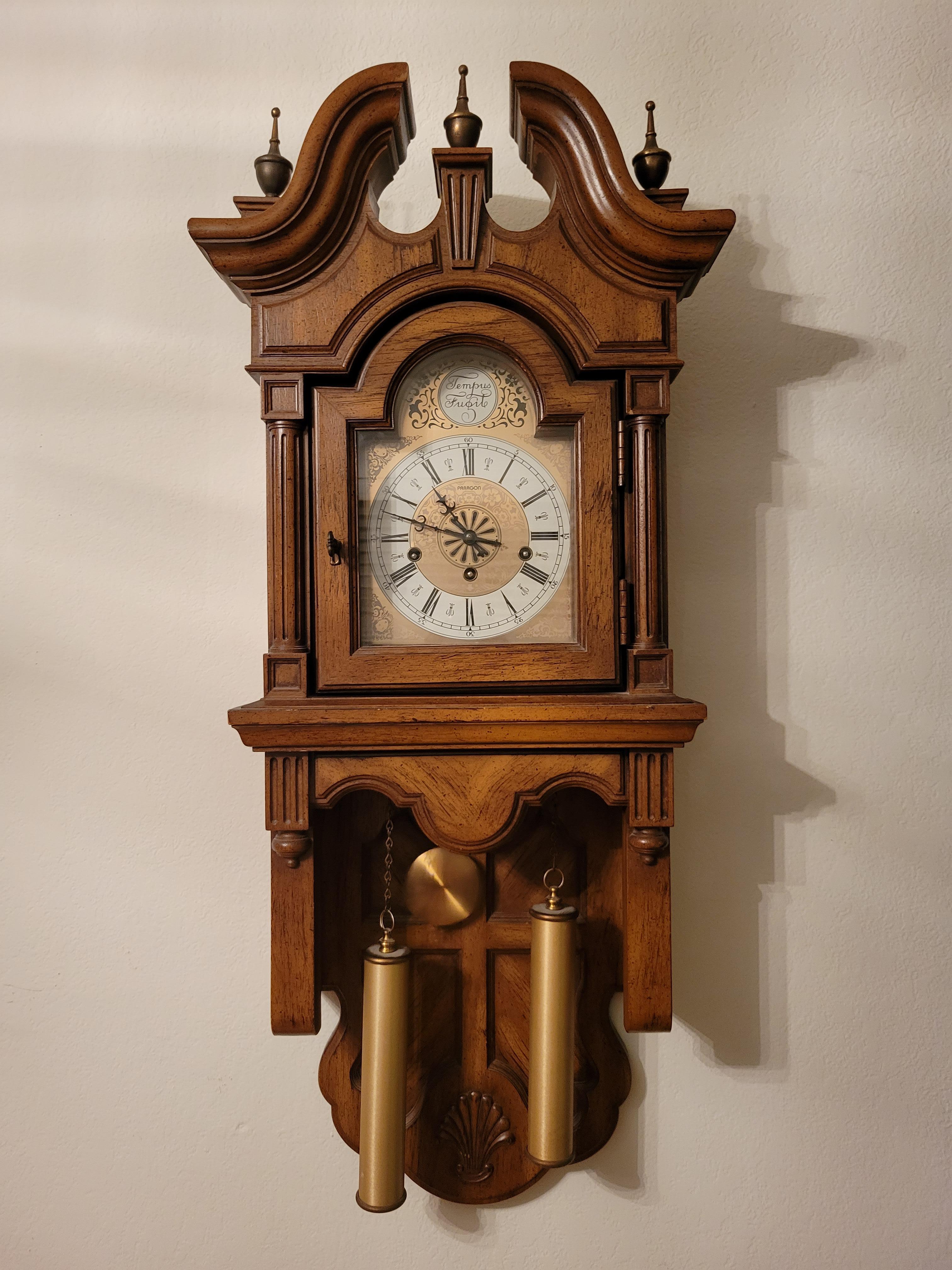 Vintage Paragon wall clock with Franz Hermle movement with a beautiful Westminster chime. It chimes 4 notes on 15 minutes, 8 notes at 30 minutes, 12 notes at 45 mintes and 16 notes on the hour.  The movement winds up with a key. The weights serve as