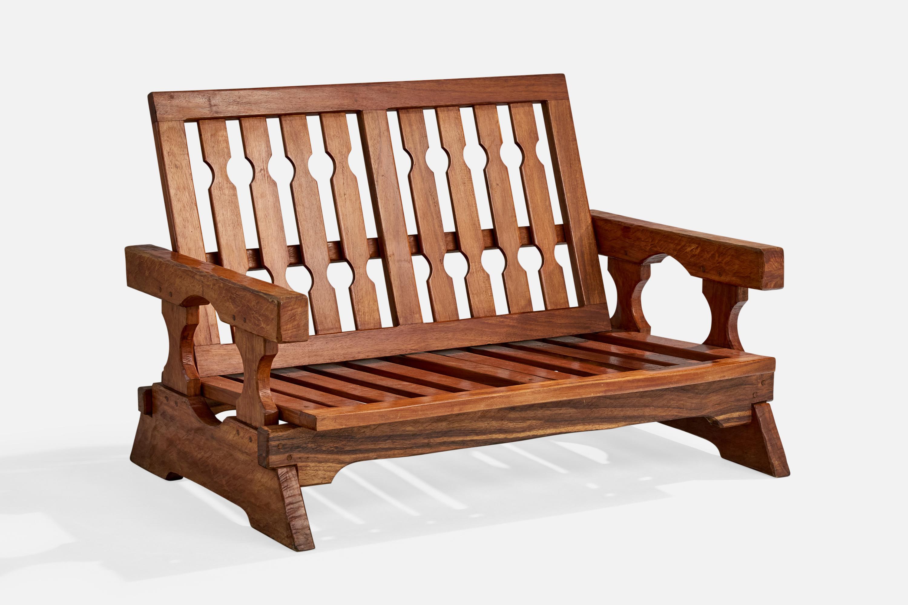 A carved sofa designed and produced in Paraguay, c. 1970s.

Wear to wood consistent with age and use

Seat back is adjustable; measured as shown

Overall Dimensions (inches): 35.0