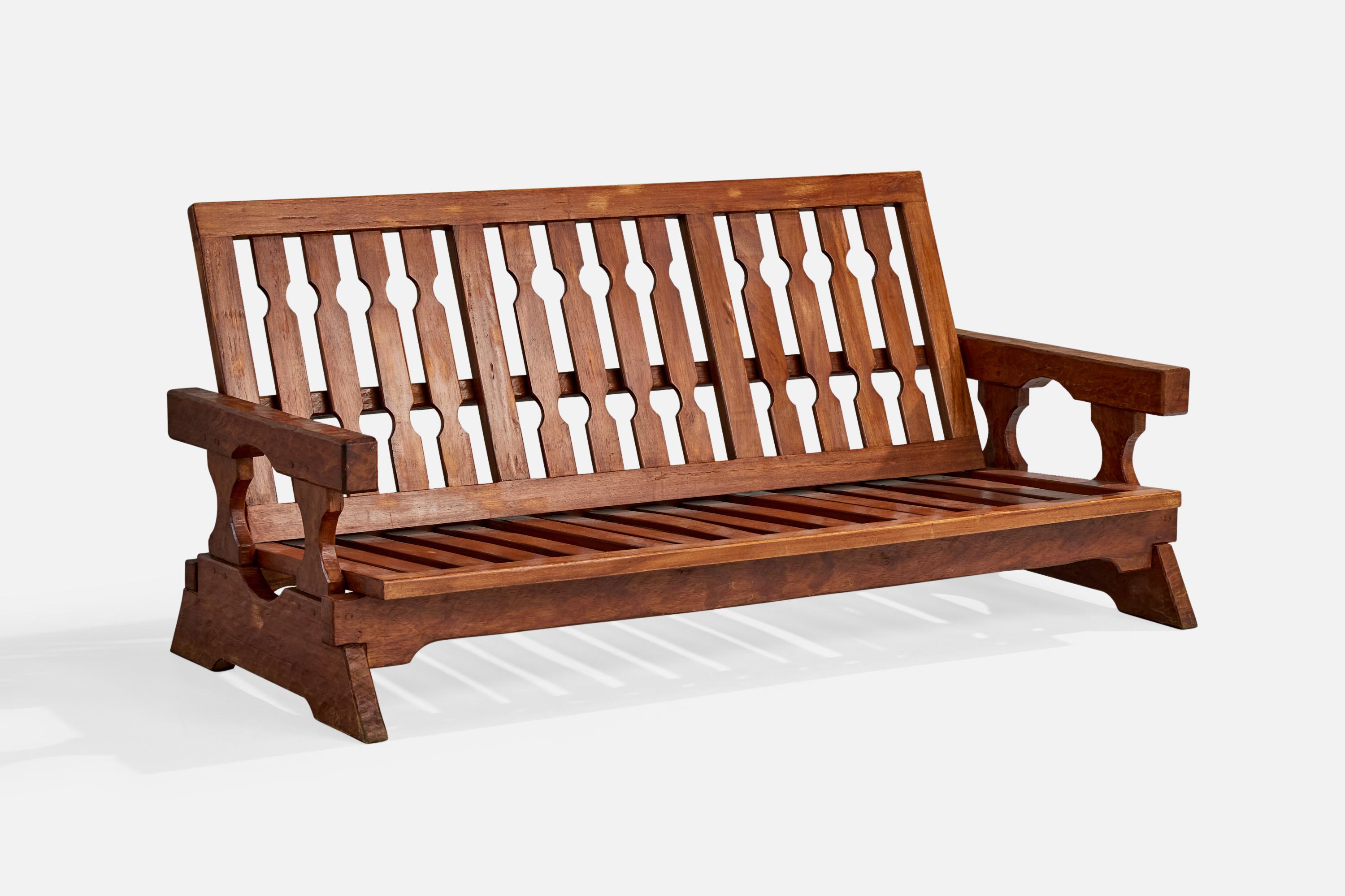 A carved wood sofa designed and produced in Paraguay, c. 1970s.

Wear to wood consistent with age and use

Seat back is adjustable; measured as shown

Overall Dimensions (inches): 35.0