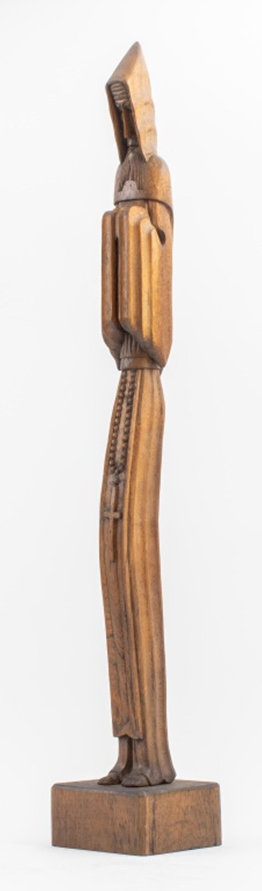 Modern carved wood statue sculpture of a standing priest or monk wearing a hooded robe and rosary, mounted on a square wood base, 