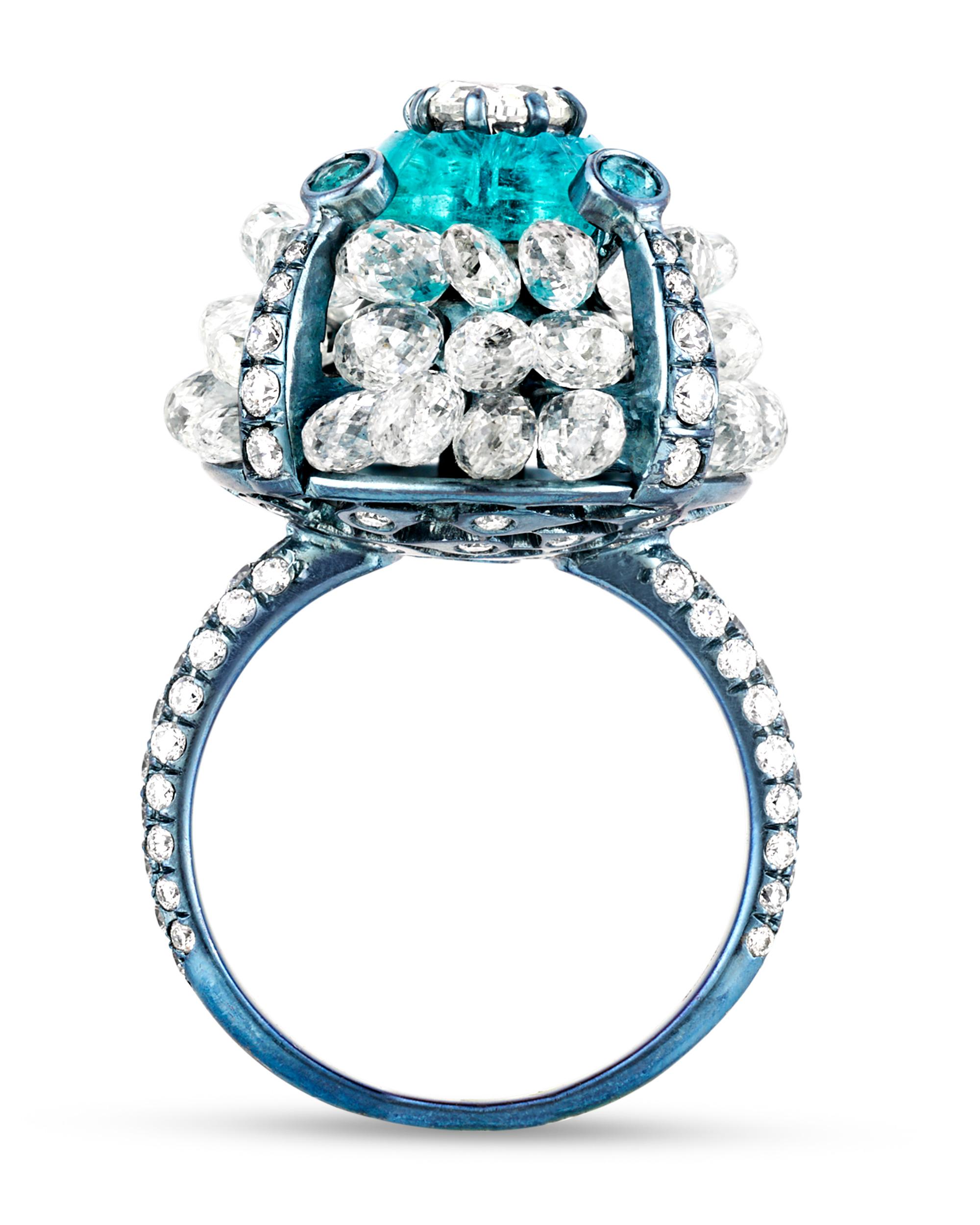 This stylish ring boasts rare Paraiba tourmaline stones weighing 3.08 carats with 21.62 total carats of white diamonds. Evoking the popular evil eye motif — an ancient protective talisman — this ring's highly unique sculptural blue titanium setting