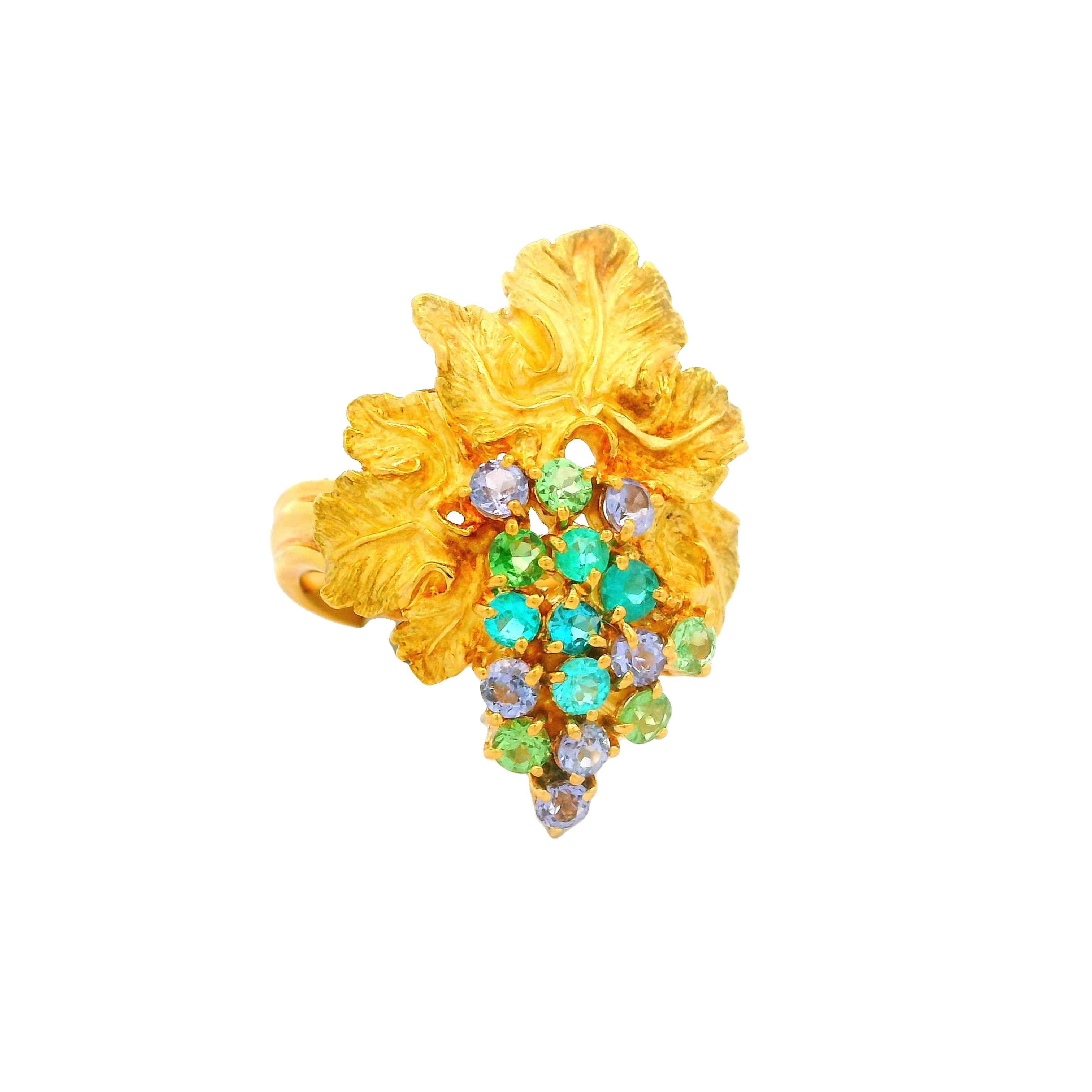 A captivating 18k yellow gold ring, showcasing a cluster of round Paraiba Tourmalines, weighing a total of 1 carat, with a mesmerizing display of various colors. Paraiba tourmaline forms in 3 different colors, blue (which is the most well known), as