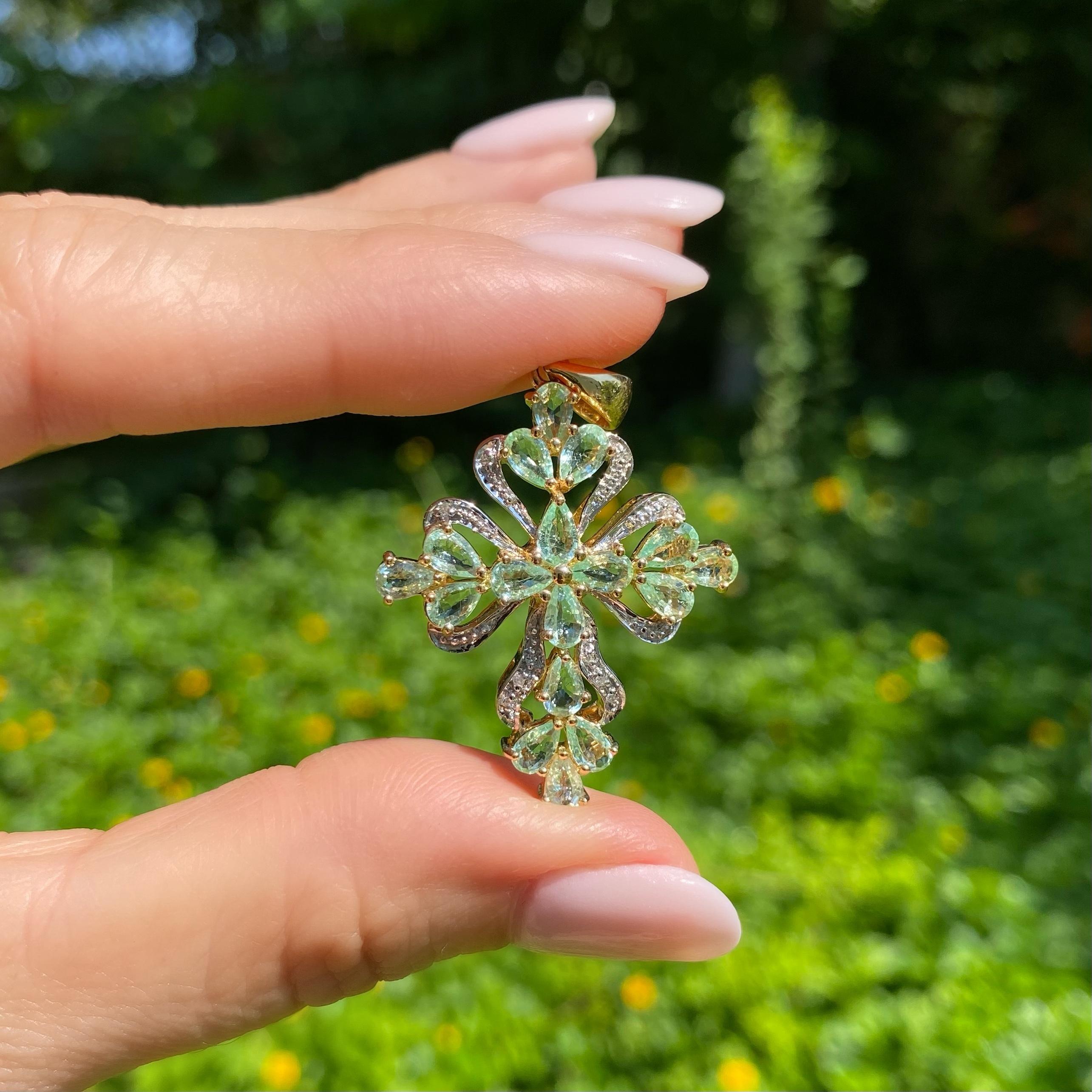 Simply Beautiful! Paraiba Tourmaline and Diamond Gold Cross Pendant, Artistically Hand crafted and set with Teardrop Paraiba Tourmaline, weighing approx. 2.86tcw, and Diamonds, approx. 0.03 total Carats. Dimensions: 1.70”l x 1.15”w x 0.29”h. Finely