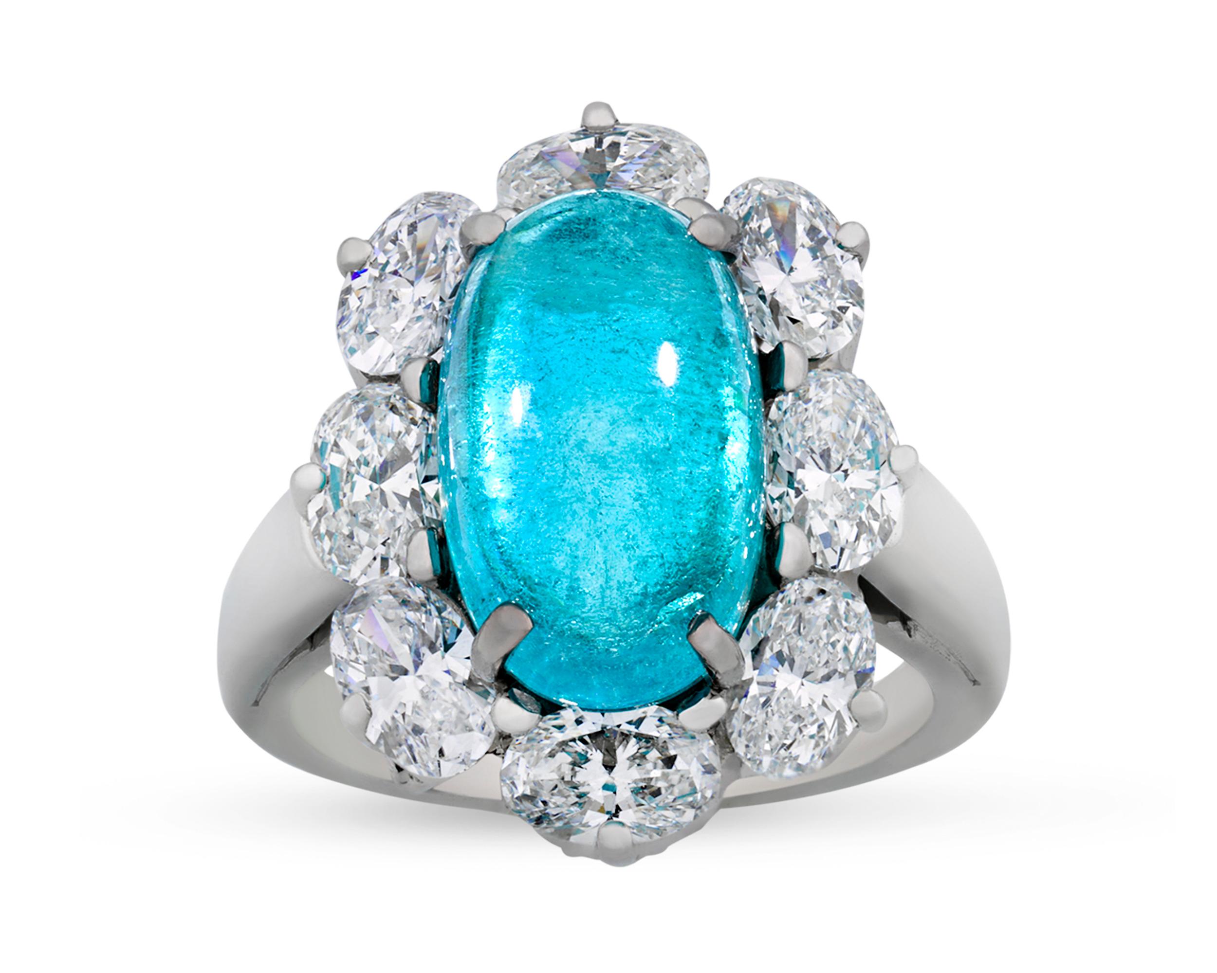 A 5.17-carat cabochon Paraiba tourmaline displays a remarkable intensity of color at the center of this ring by the celebrated Oscar Heyman. Its electric blue color is certified by the Gübelin Gemlab as being natural and Brazilian in origin. Set in