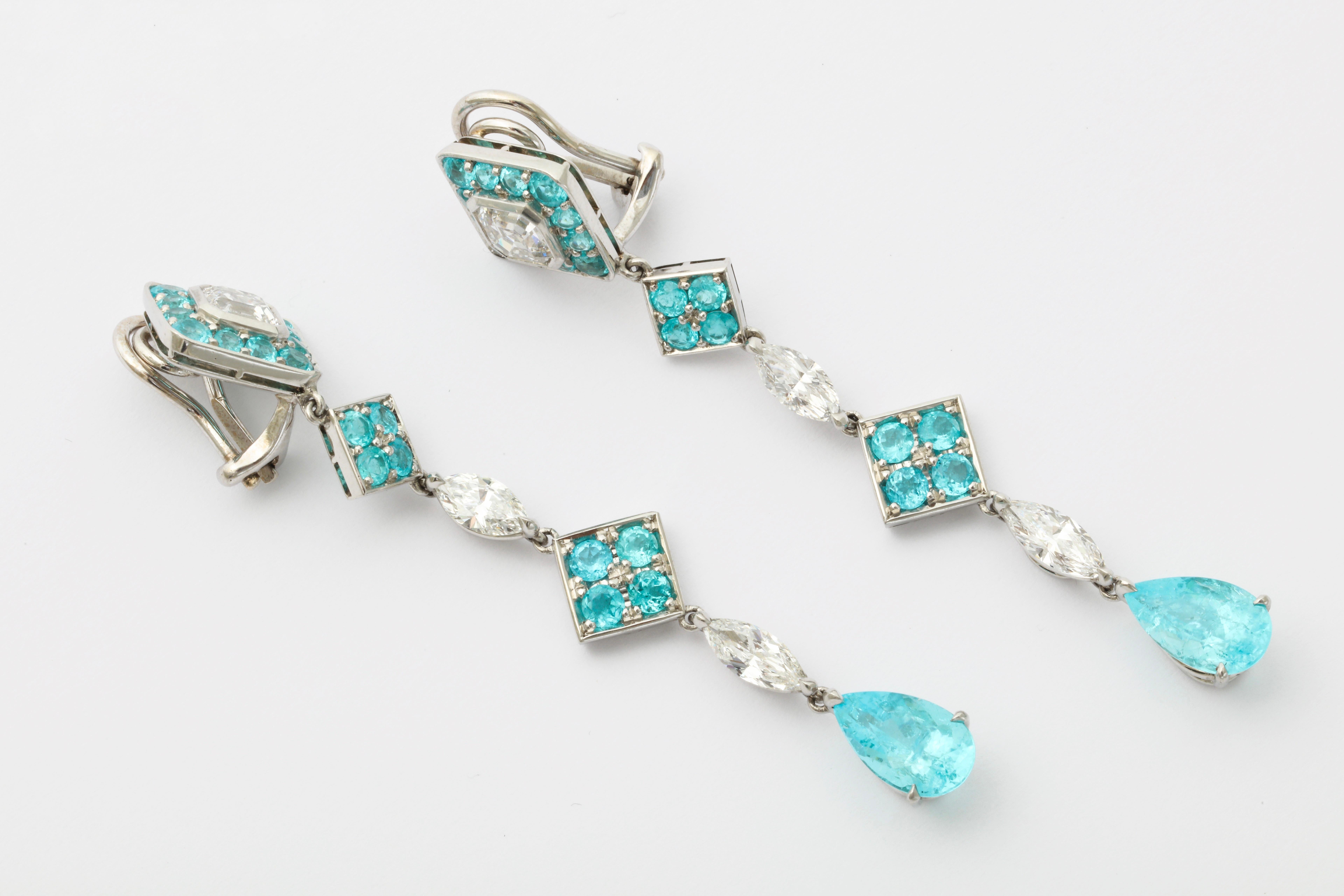 The quintessential shoulder duster earrings, featuring the most sought after tourmalines from Paraiba, Brazil.  The matching pear shape Paraibas are mounted with very high quality emerald cut and marquise diamonds as well as smaller round Paraibas. 