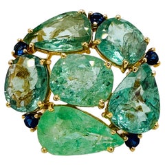 Anillo redondo de turmalina paraiba de forma mixta y zafiro azul en oro amarillo de 18 quilates
