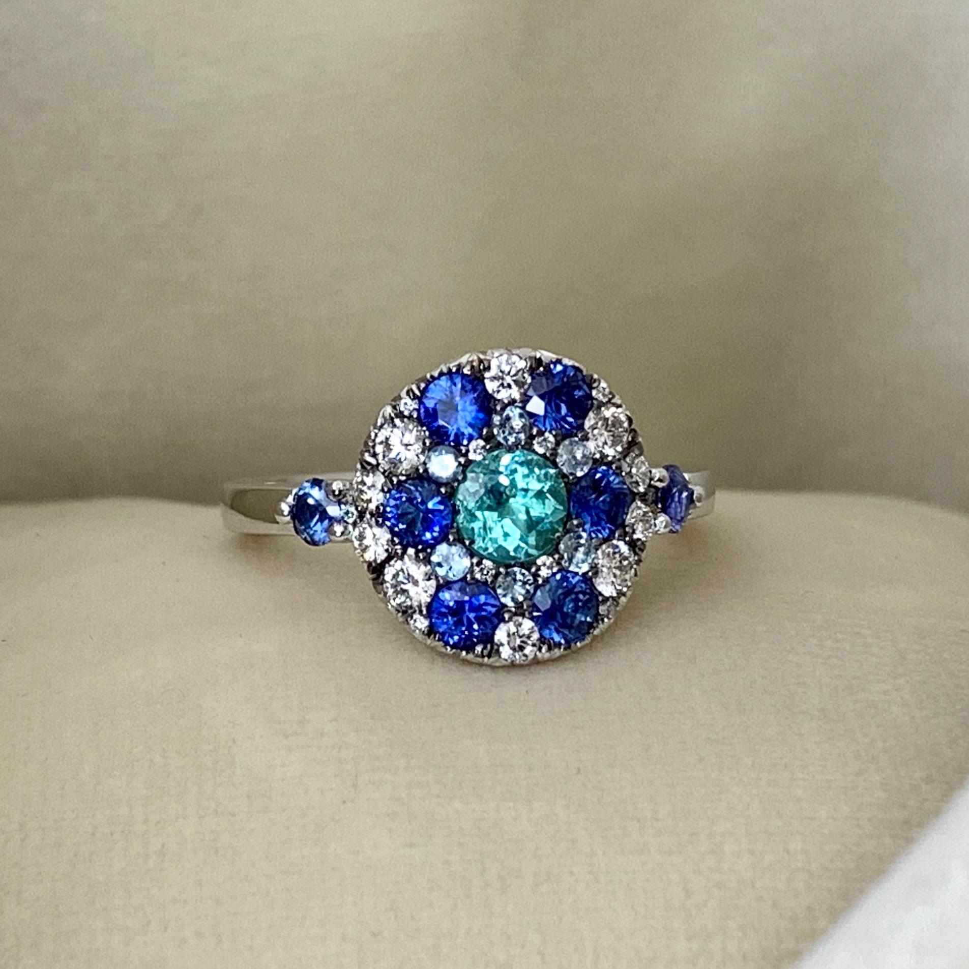 One of a kind ring handmade in Belgium from jewellery designer Joke Quick.  Handmade the traditional way, no casting or printing involved. The ring is made in 18K White gold 8,6 g. Set with a Paraiba Tourmaline centerstone 0,41 Carat.( no